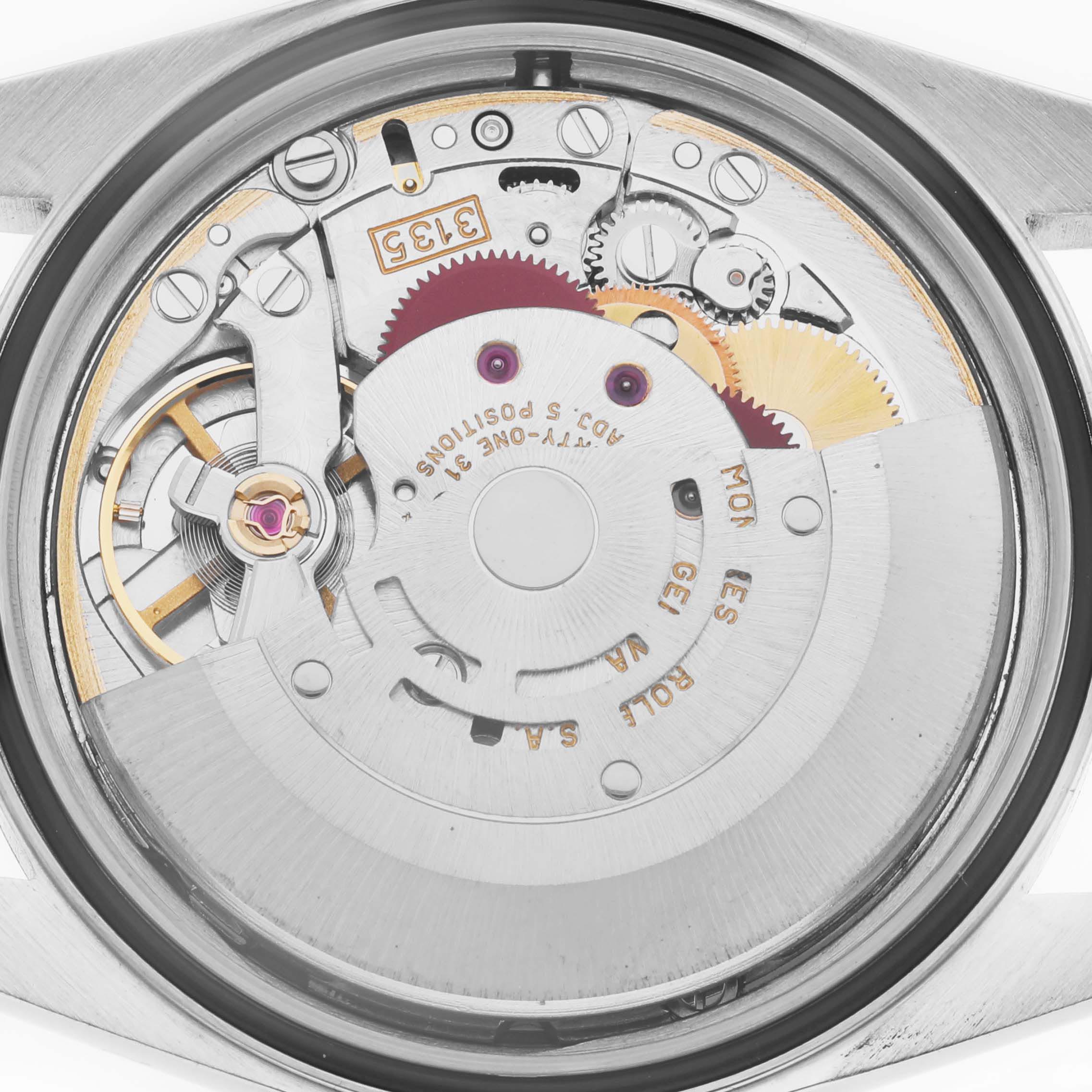 The image shows the movement of a Rolex Datejust 16233 Men
s Steel and Gold (two tone) White Dial 16233 Men
s Steel and Gold (two tone) White Dial watch from a rear angle, revealing gears and intricate internal mechanisms.