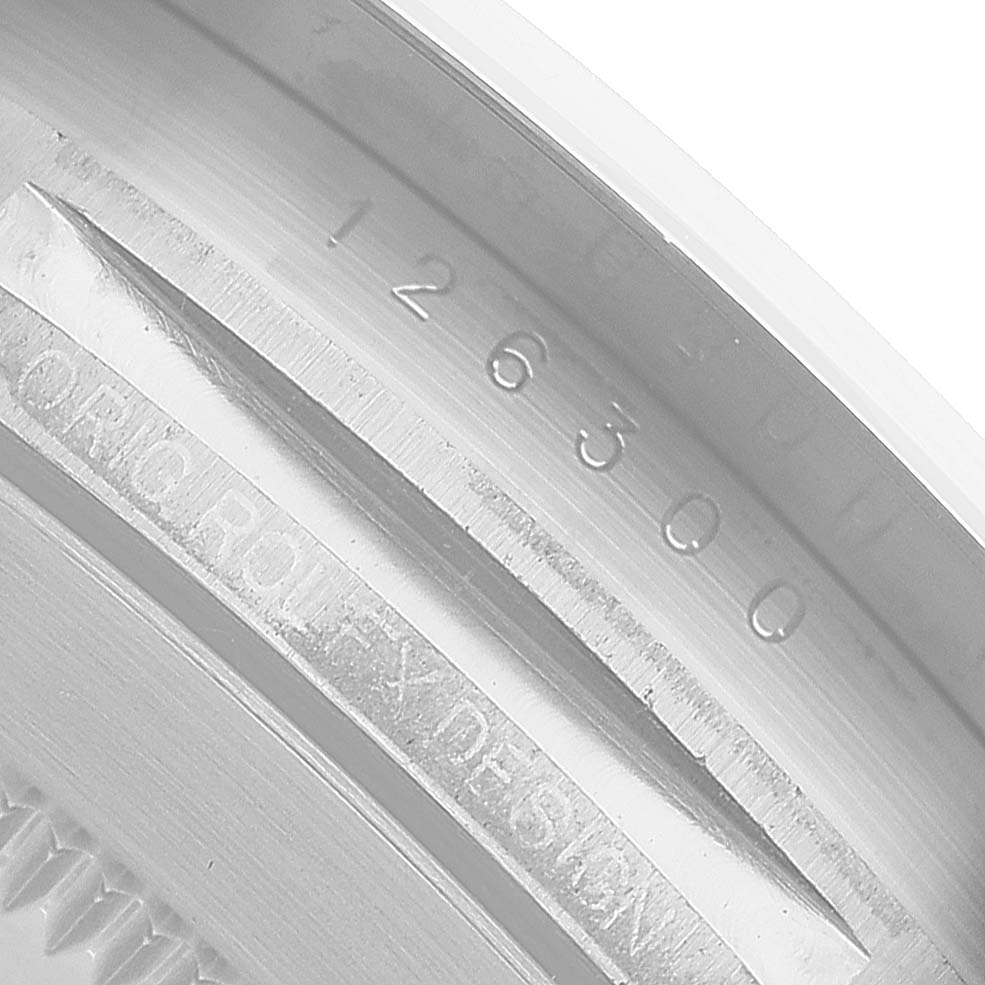 The image shows the inner bezel of a Rolex Datejust 41 126300 Mens Stainless Steel Black Dial, featuring engraved serial numbers and branding details.