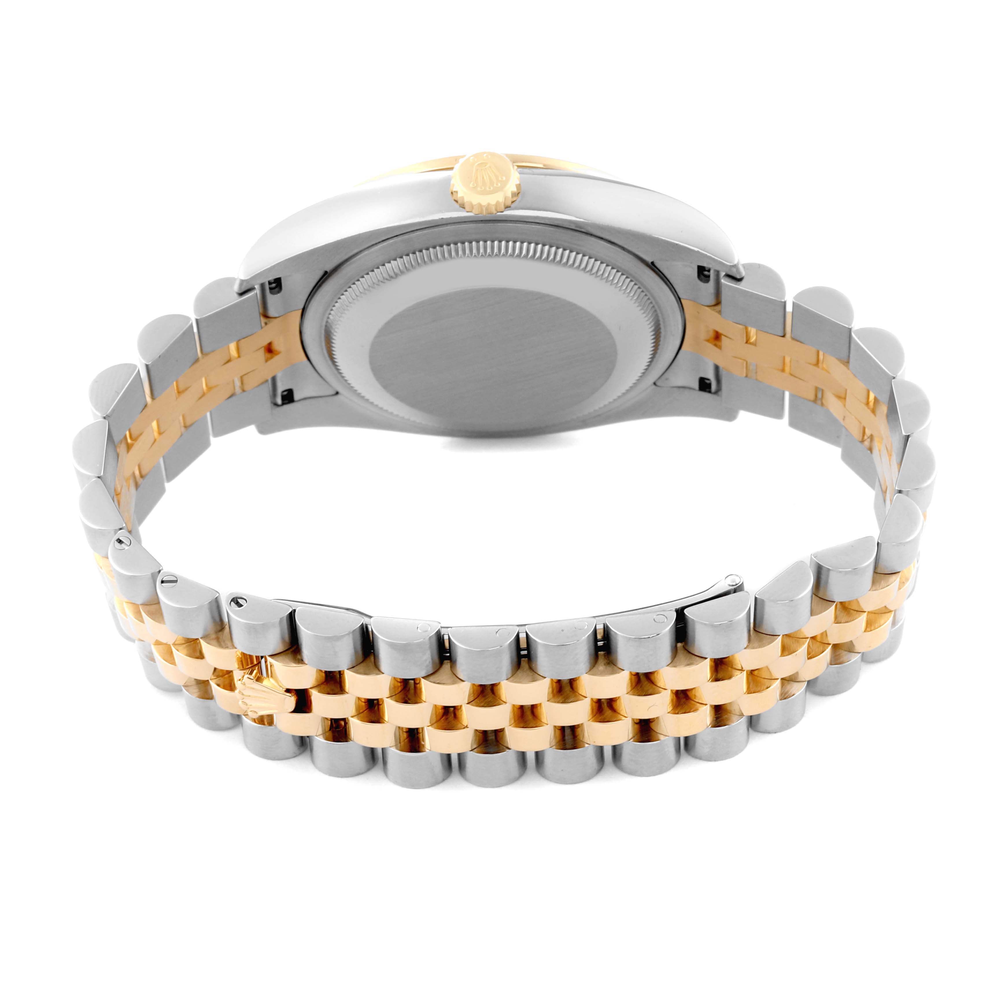 The image shows the underside of a Rolex Datejust 116243 Men's Steel and Gold (two tone) Champagne Dial 116243 Men's Steel and Gold (two tone) Champagne Dial watch, highlighting its case back, crown, and two-tone Jubilee bracelet.