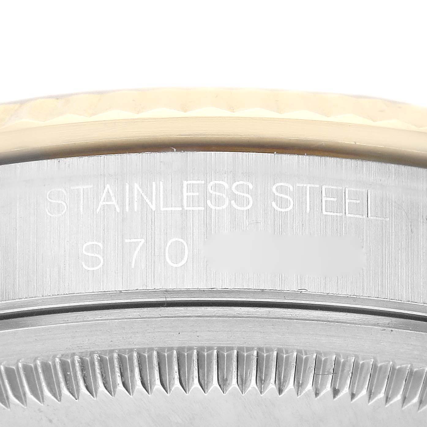 This close-up angle shows the caseback and part of the bezel of a Rolex Datejust 16233 Men's Steel and Gold (two tone) White Dial 16233 Men's Steel and Gold (two tone) White Dial, highlighting "STAINLESS STEEL" engraving.