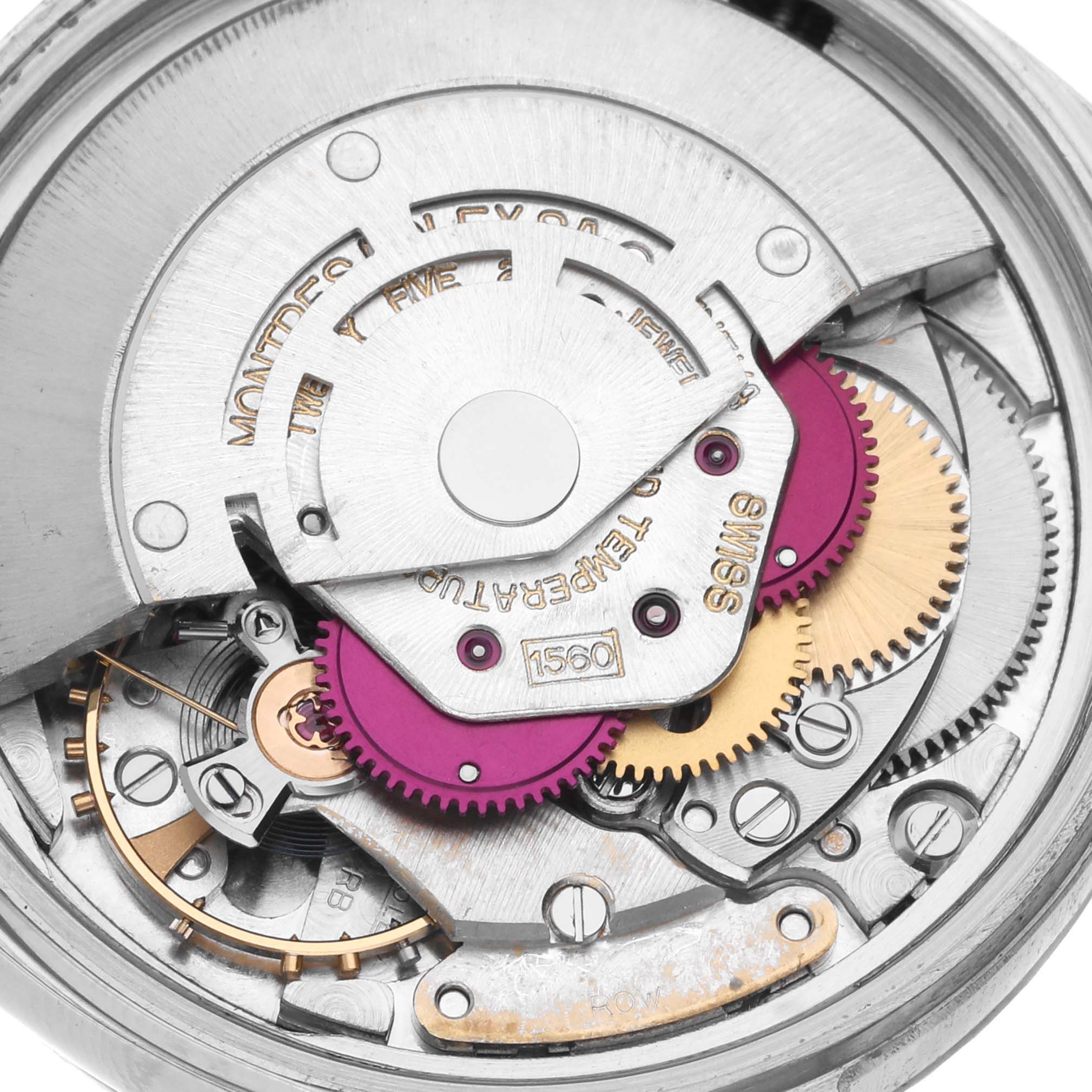 The image shows a close-up of the movement mechanism of a Rolex Vintage Collection 16030 Men's Stainless Steel Silver Dial 16030 Men's Stainless Steel Silver Dial model watch, revealing gears and intricate parts.