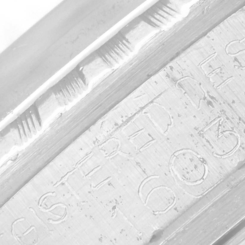 The image shows a close-up of the engraved text and fluted bezel edge of a Rolex Vintage Collection 16030 Men's Stainless Steel Silver Dial 16030 Men's Stainless Steel Silver Dial watch.