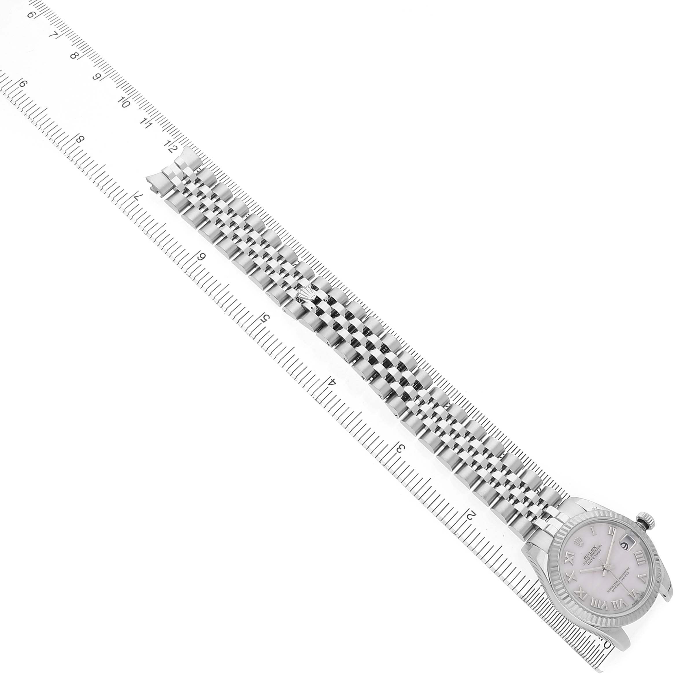 The image shows a Rolex Mid-Size 178274 Women's Stainless Steel Mother of Pearl Dial watch from an angled side view, displaying the bracelet against a ruler for scale.