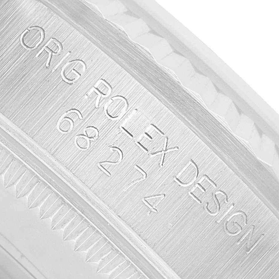 The image shows a close-up of the bezels edge and engravings on the Rolex Mid-Size 68274 Womens Stainless Steel White Dial model.