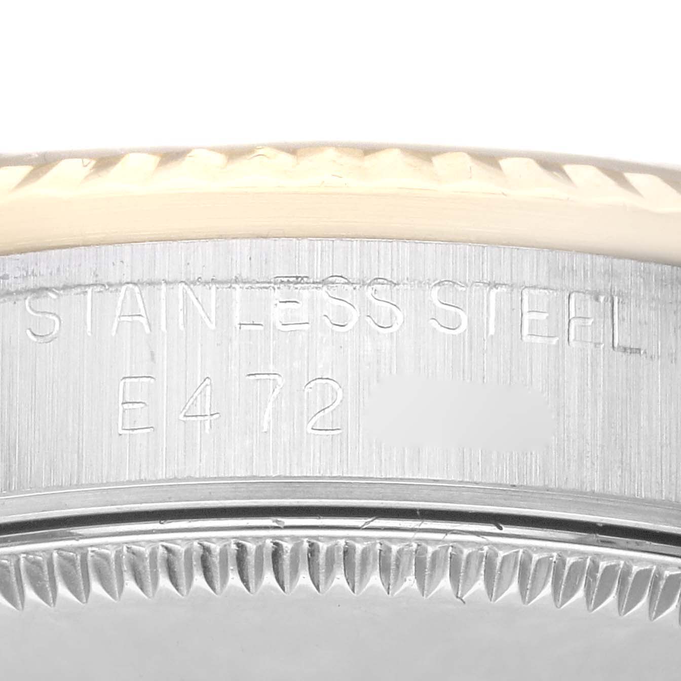This image shows a close-up of the side of a Mid-Size Rolex watch, focusing on the stainless steel part and an engraved serial number.