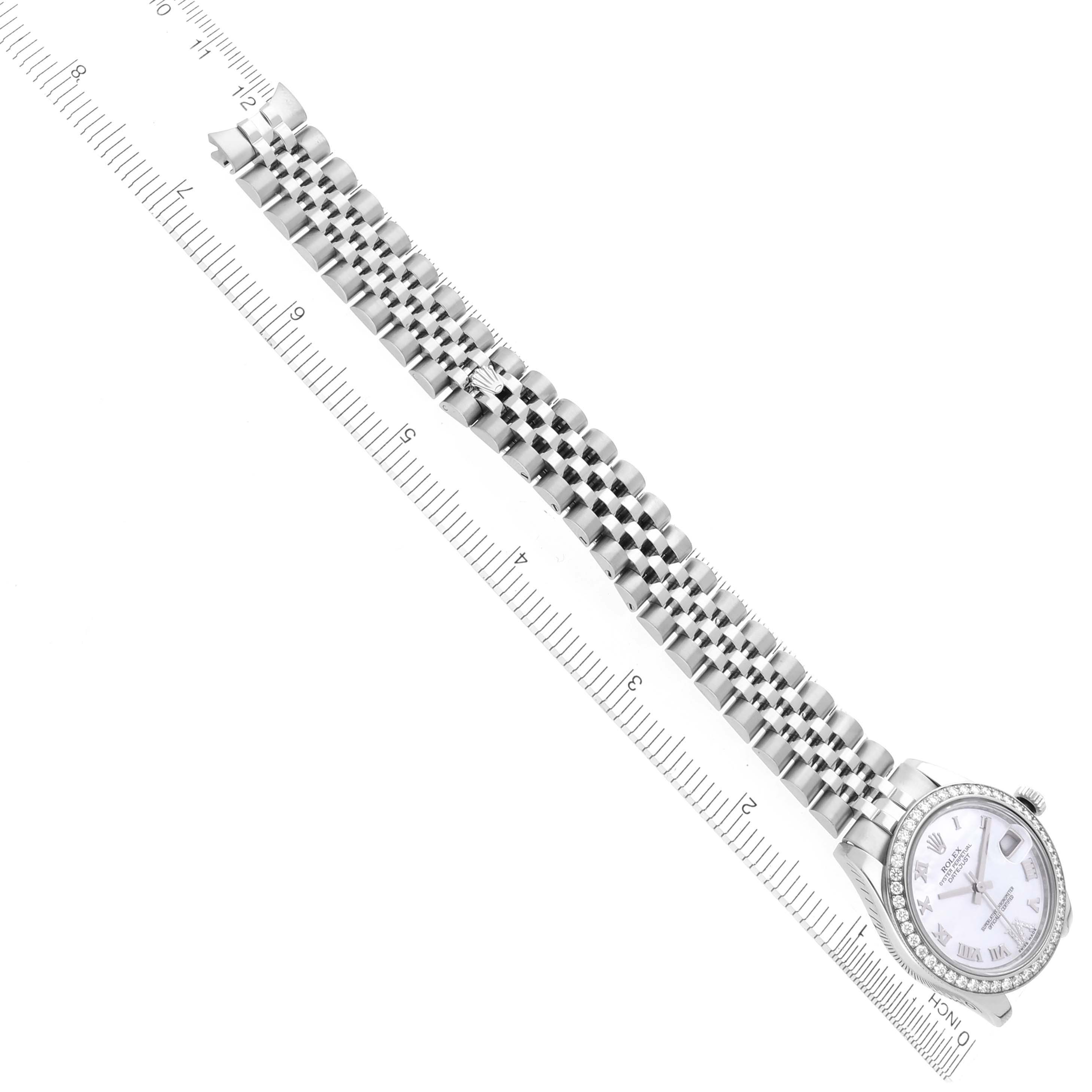 The Rolex Mid-Size 178384 Women
s Stainless Steel Mother of Pearl Dial 178384 Women
s Stainless Steel Mother of Pearl Dial watch is displayed diagonally, showing the face, bezel, and full bracelet alongside a ruler for scale.