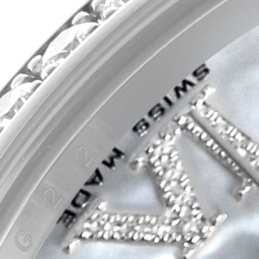 The image shows a close-up of the bezel and dial edge of a Mid-Size Rolex, featuring diamonds and text.