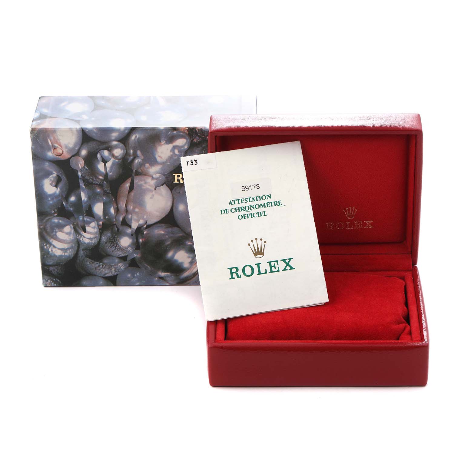 The image shows a red Rolex Datejust 69173 Women
s Steel and Gold (two tone) Red Dial 69173 Women
s Steel and Gold (two tone) Red Dial box with its certificate and an outer sleeve featuring a pearl-like design.