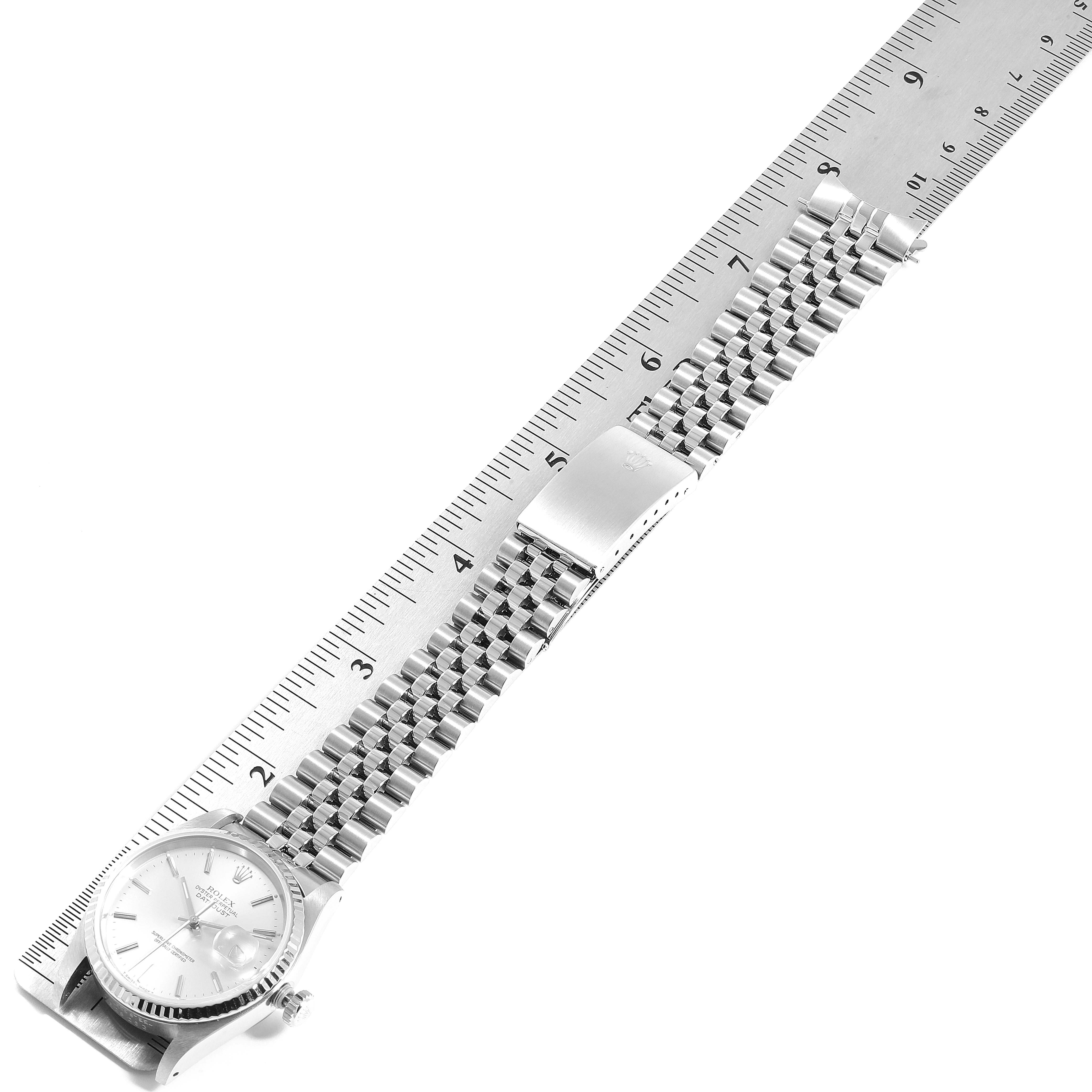 A Rolex Datejust 16234 Men's Stainless Steel Silver Dial 16234 Men's Stainless Steel Silver Dial watch is displayed horizontally, showing its dial, bracelet, and clasp alongside a ruler.