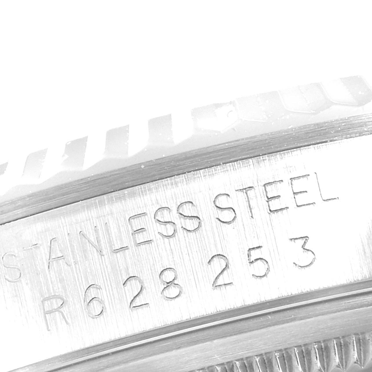 This image shows a close-up view of the bezel and engraved serial number of a Rolex Datejust 16234 Men's Stainless Steel Silver Dial 16234 Men's Stainless Steel Silver Dial watch.