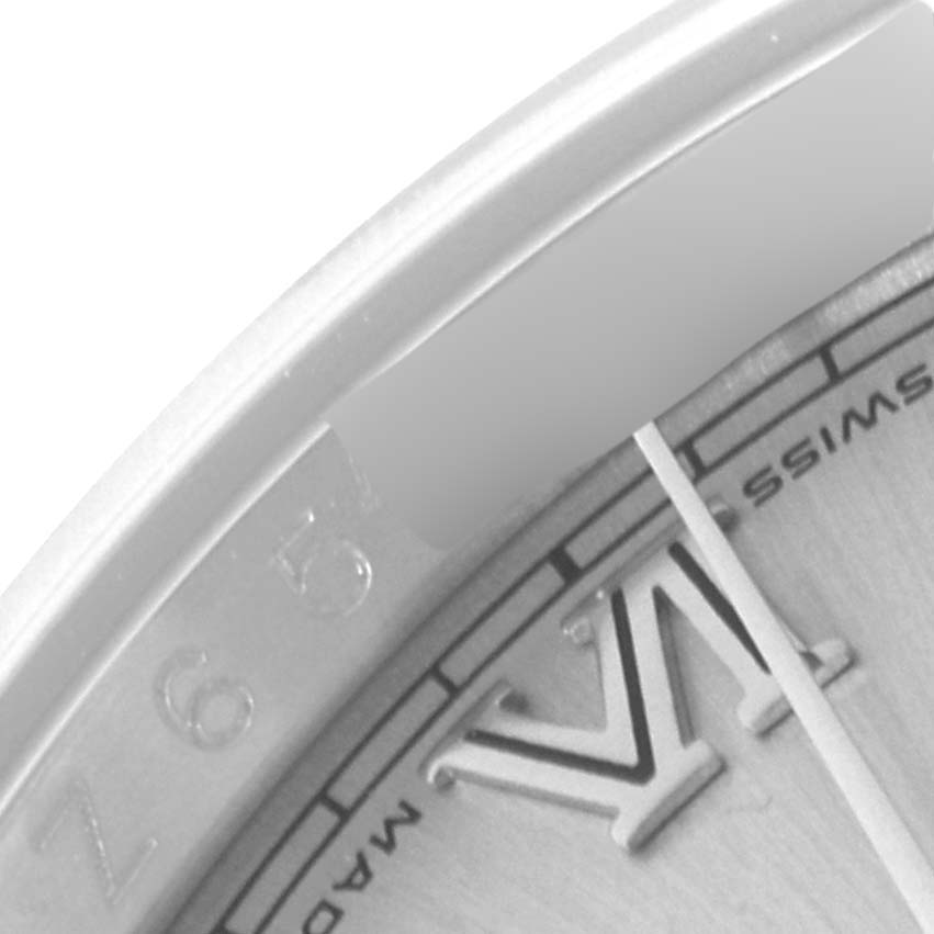 This close-up image of a Rolex Datejust 116200 Men
s Stainless Steel Silver Dial 116200 Men
s Stainless Steel Silver Dial watch shows a partial view of the dial, including the Roman numeral VI and the "Swiss Made" text.