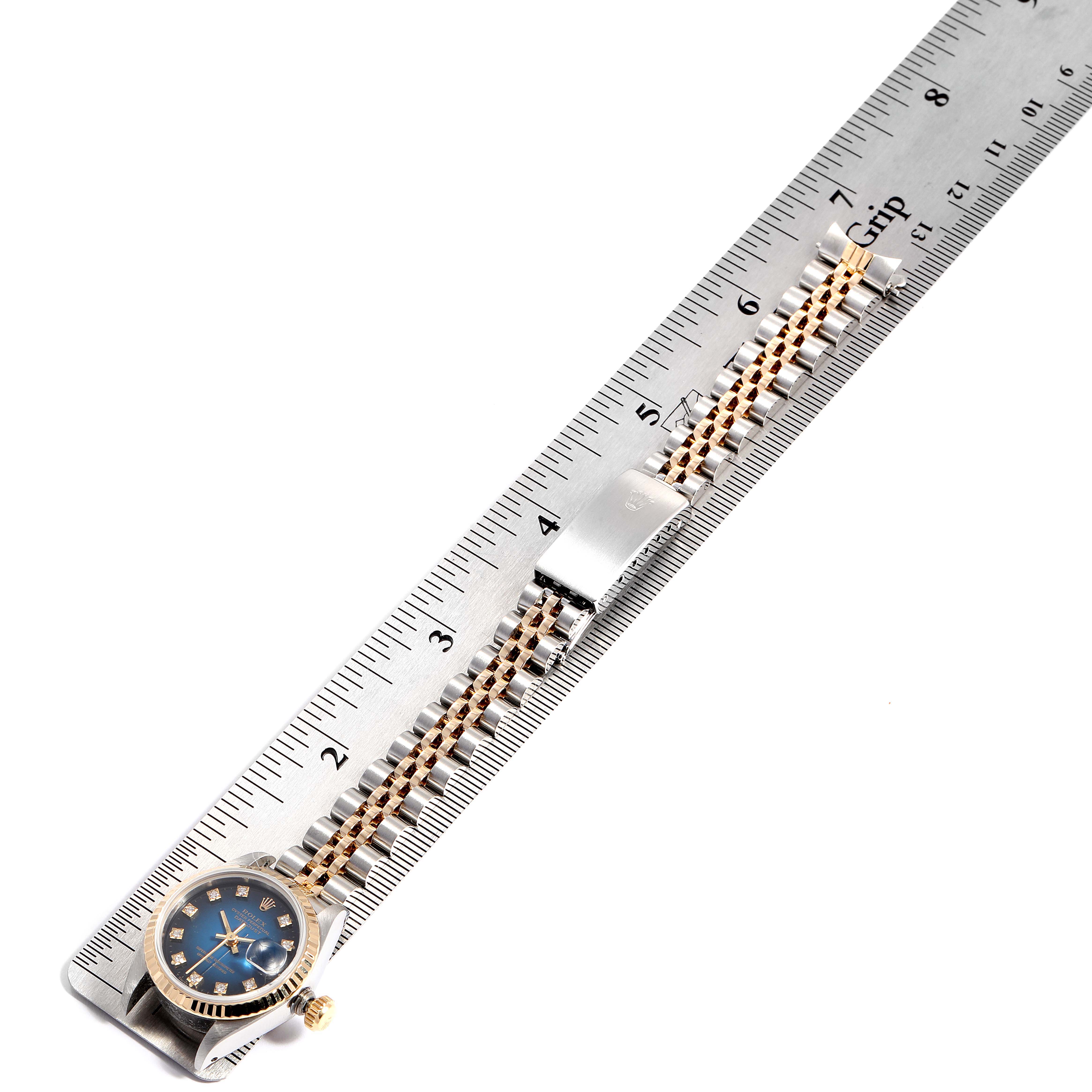 The image shows a Rolex Datejust 69173 Women's Steel and Gold (two tone) Blue Dial 69173 Women's Steel and Gold (two tone) Blue Dial watch laid flat alongside a ruler, displaying the face, crown, and bracelet.