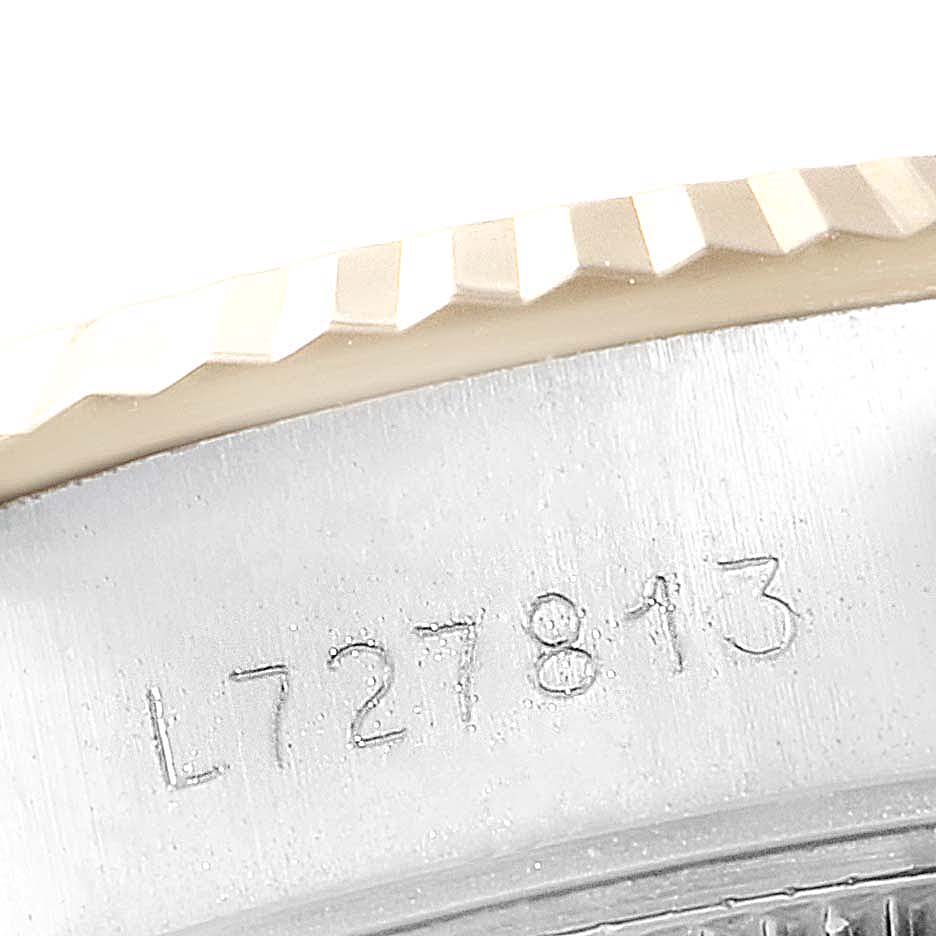 The image shows a close-up of the serial number and the fluted bezel of a Rolex Datejust 69173 Women's Steel and Gold (two tone) Blue Dial 69173 Women's Steel and Gold (two tone) Blue Dial watch.