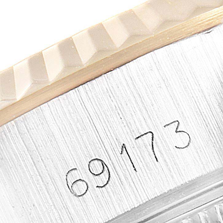 This photo shows a close-up of the serial number and fluted bezel on a Rolex Datejust 69173 Women's Steel and Gold (two tone) Blue Dial 69173 Women's Steel and Gold (two tone) Blue Dial watch.