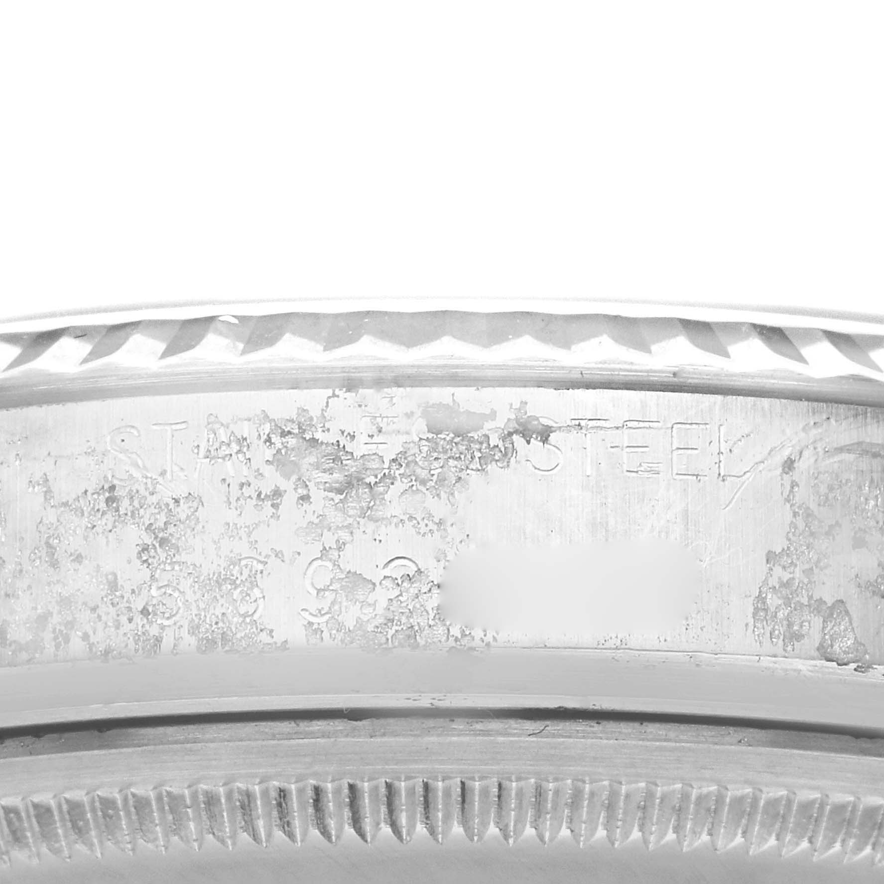 This image shows a close-up of the engraved bezel and the outer edge of the case, focusing on the serial number, of a Rolex Vintage Collection 16014 Men's Stainless Steel Silver Dial 16014 Men's Stainless Steel Silver Dial watch.