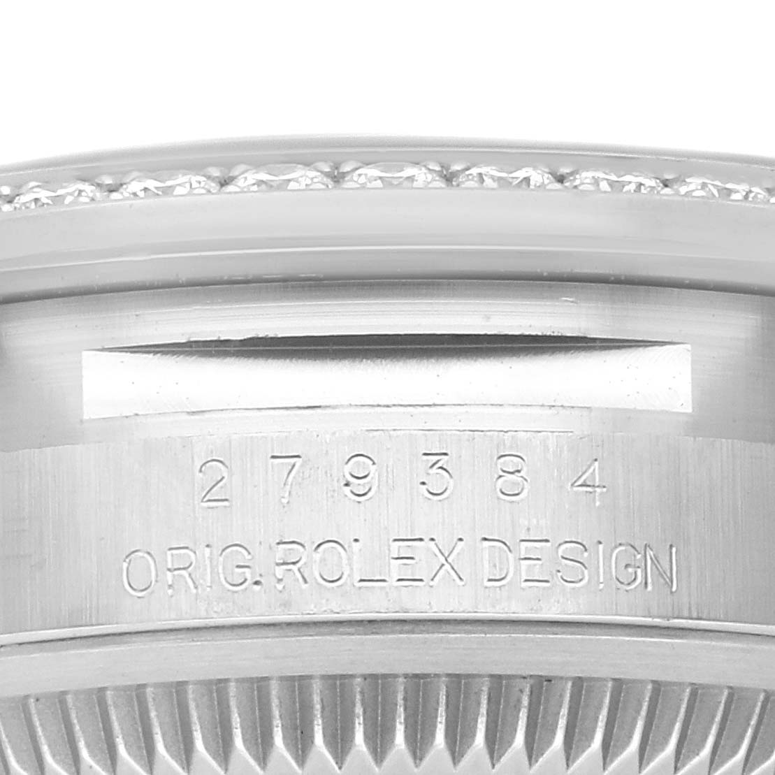 This image shows a close-up of the engraving on the side of the Rolex Datejust 279384RBR Women
s Stainless Steel Grey Dial 279384RBR Women
s Stainless Steel Grey Dial watch, featuring the serial number and design details.