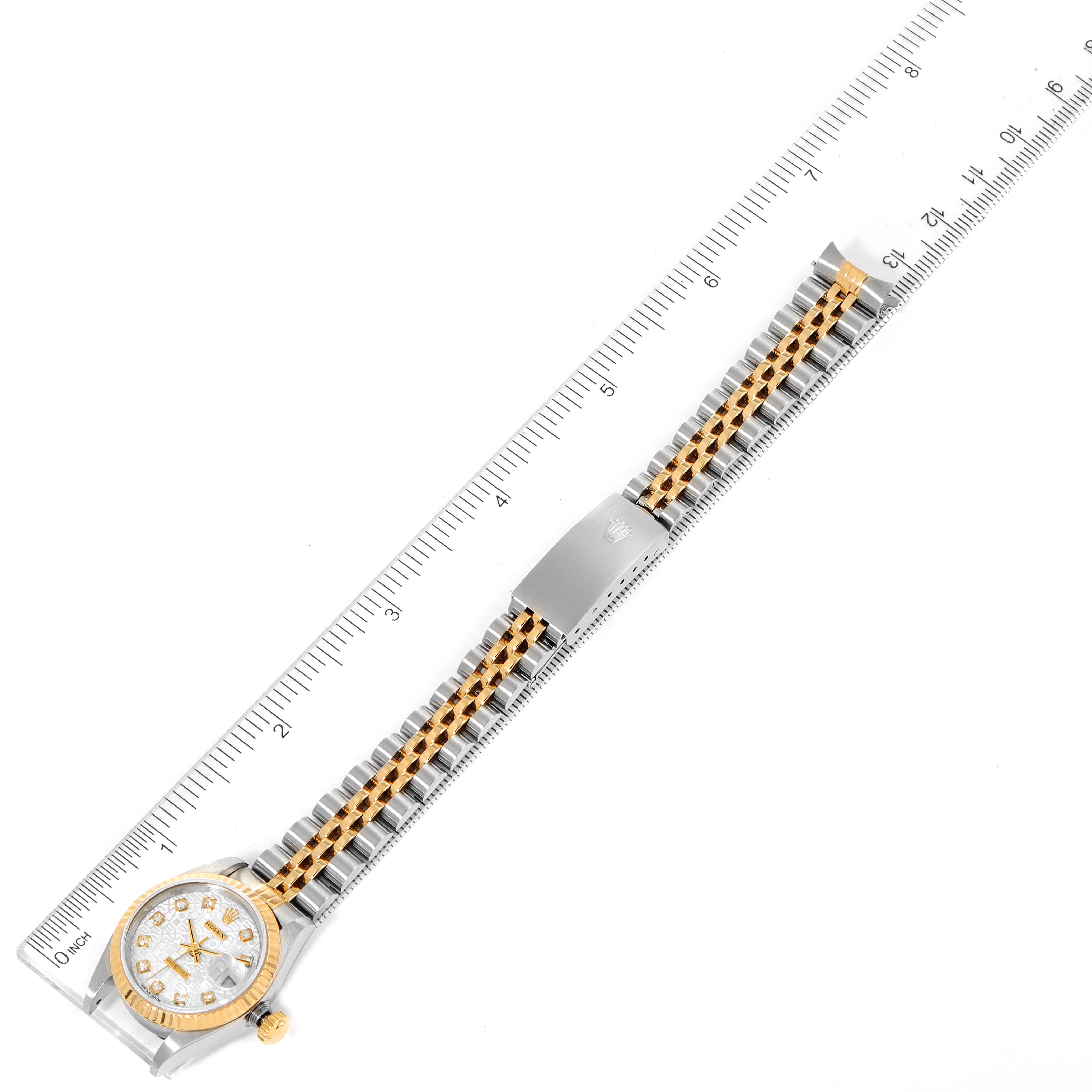 The image shows a Rolex Datejust 69173 Women
s Steel and Gold (two tone) Silver Dial 69173 Women
s Steel and Gold (two tone) Silver Dial model watch positioned horizontally alongside a ruler, highlighting its length and bracelet details.