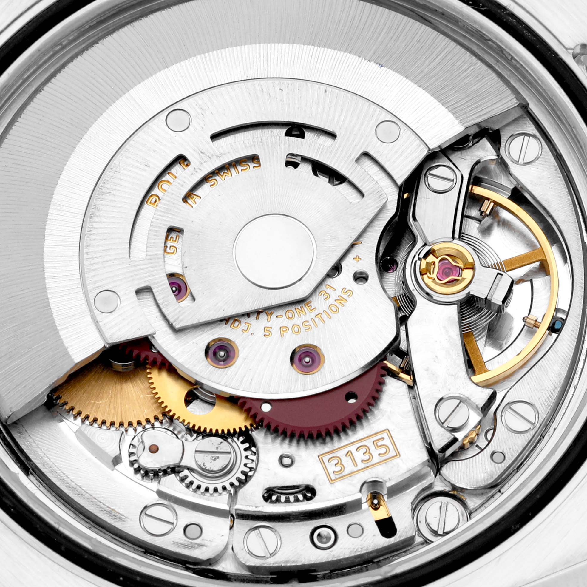 The image shows a close-up of the internal mechanism of a Rolex Datejust 116233 Men's Steel and Gold (two tone) Champagne Dial 116233 Men's Steel and Gold (two tone) Champagne Dial, highlighting gears, screws, and the automatic movement components.