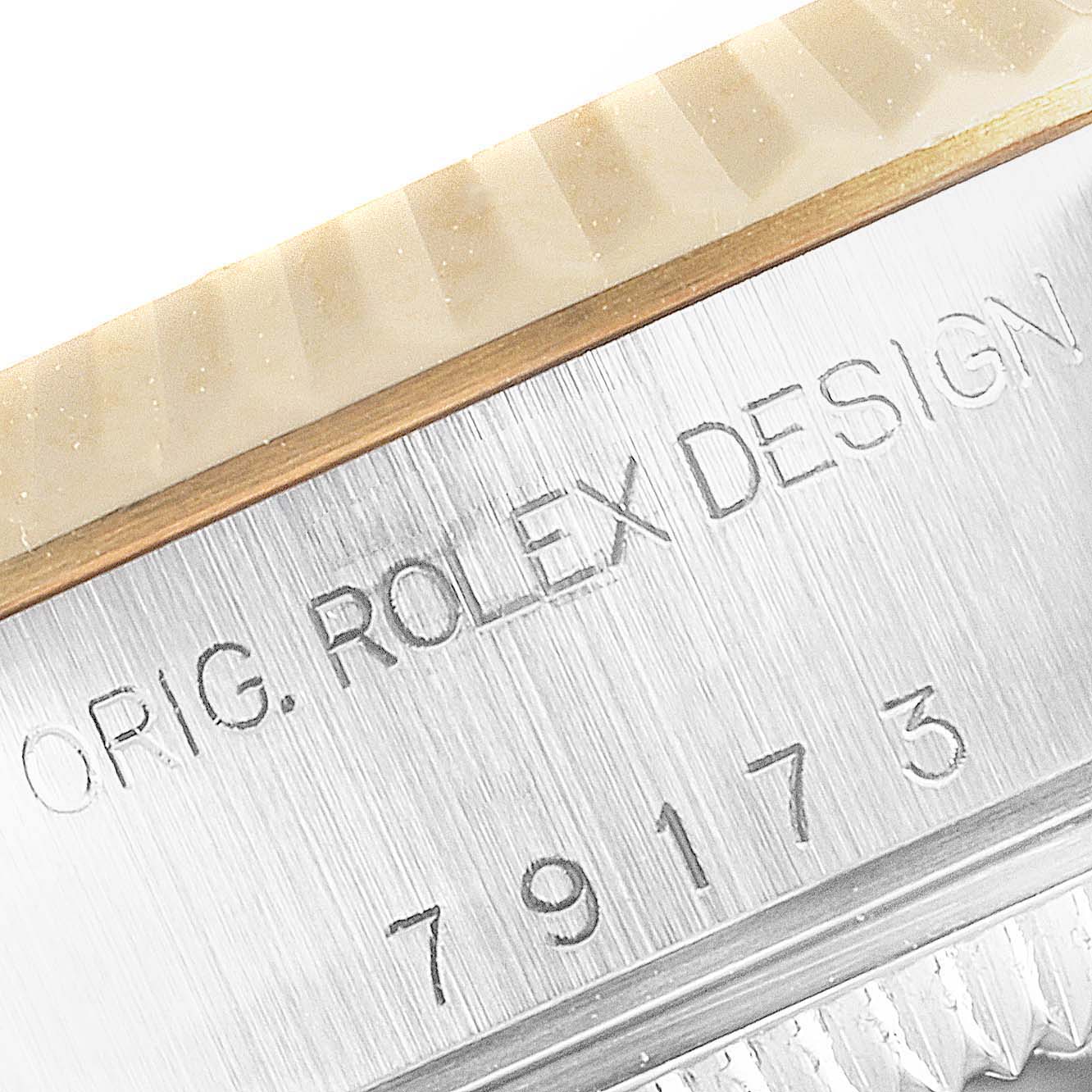 The image shows a close-up angle of the serial number and case details on a Rolex Datejust 79173 Women
s Steel and Gold (two tone) Black Dial 79173 Women
s Steel and Gold (two tone) Black Dial watch.