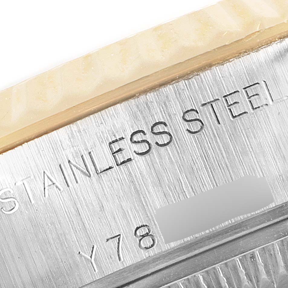 The image shows a close-up of the engraved part of the case back of the Rolex Datejust 79173 Women
s Steel and Gold (two tone) Black Dial 79173 Women
s Steel and Gold (two tone) Black Dial, highlighting "STAINLESS STEEL."