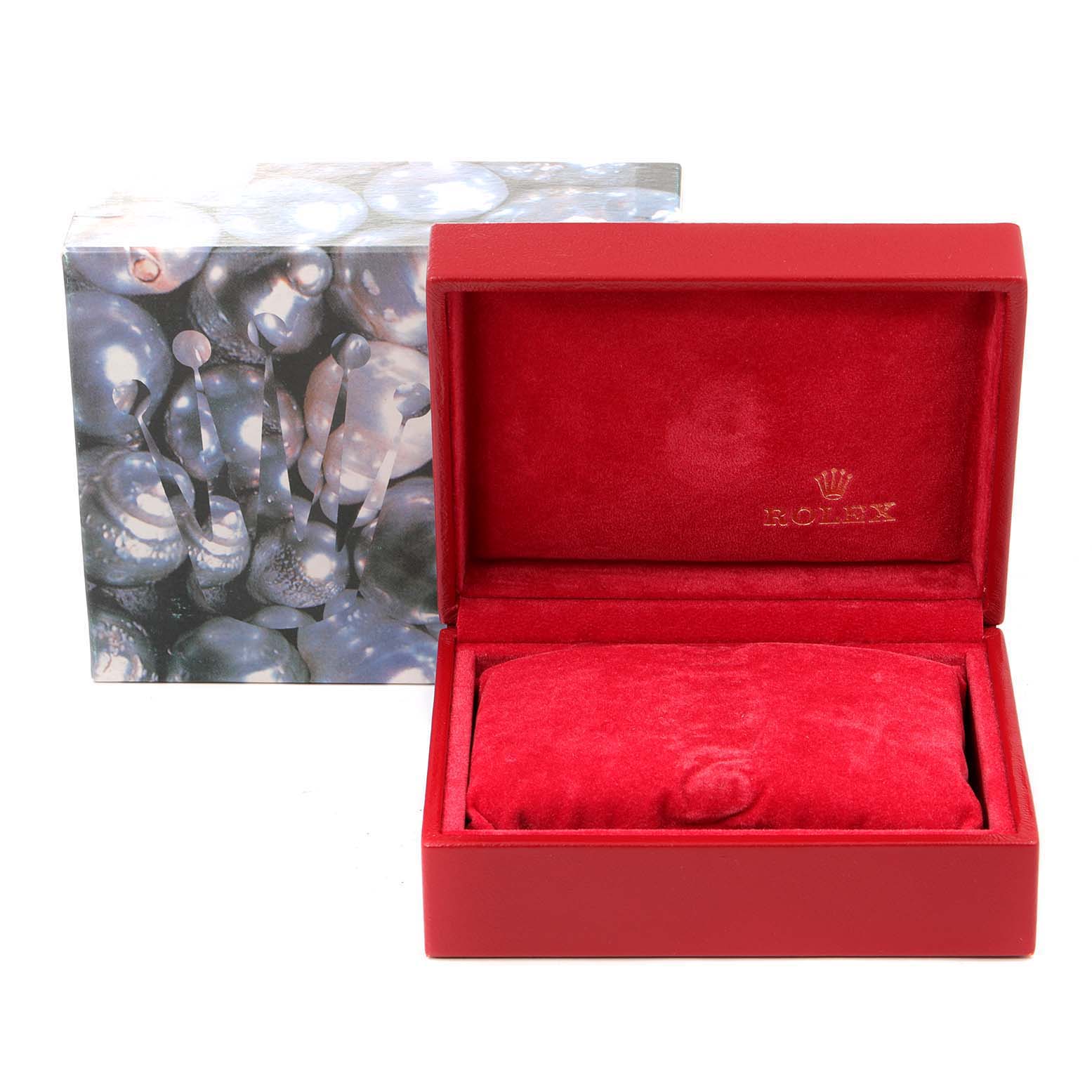The image shows a Rolex Datejust 79173 Women
s Steel and Gold (two tone) Black Dial 79173 Women
s Steel and Gold (two tone) Black Dial watch box with a red interior and an outer packaging with a pearl-like design.
