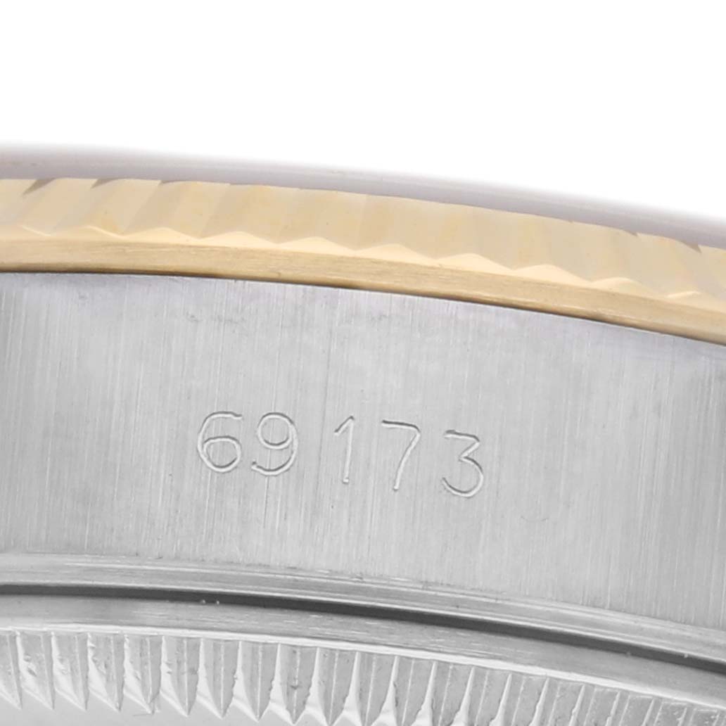 The image shows a close-up of the case side and bezel of a Rolex Datejust 69173 Women
s Steel and Gold (two tone) Champagne Dial 69173 Women
s Steel and Gold (two tone) Champagne Dial watch, highlighting the model number engraving.
