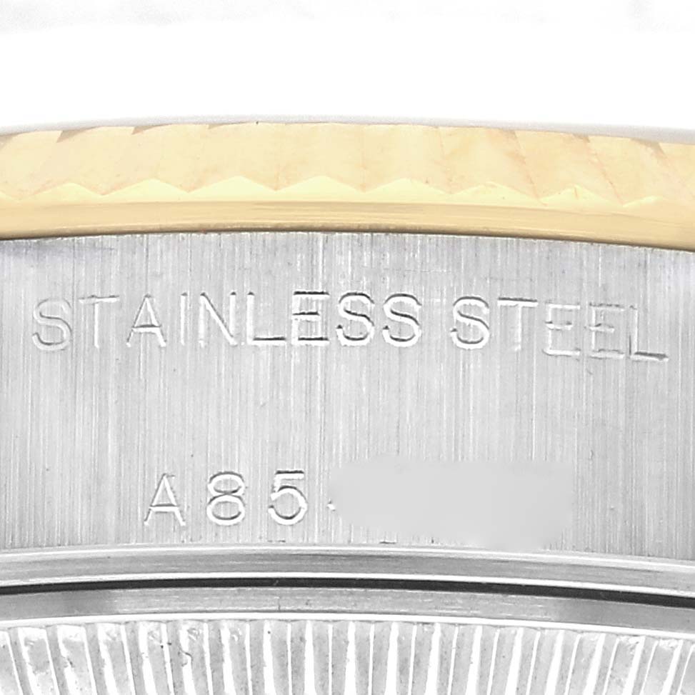 The image shows a close-up of the "STAINLESS STEEL" engraving on the back of a Rolex Datejust 79173 Women
s Steel and Gold (two tone) Champagne Dial 79173 Women
s Steel and Gold (two tone) Champagne Dial watch case.