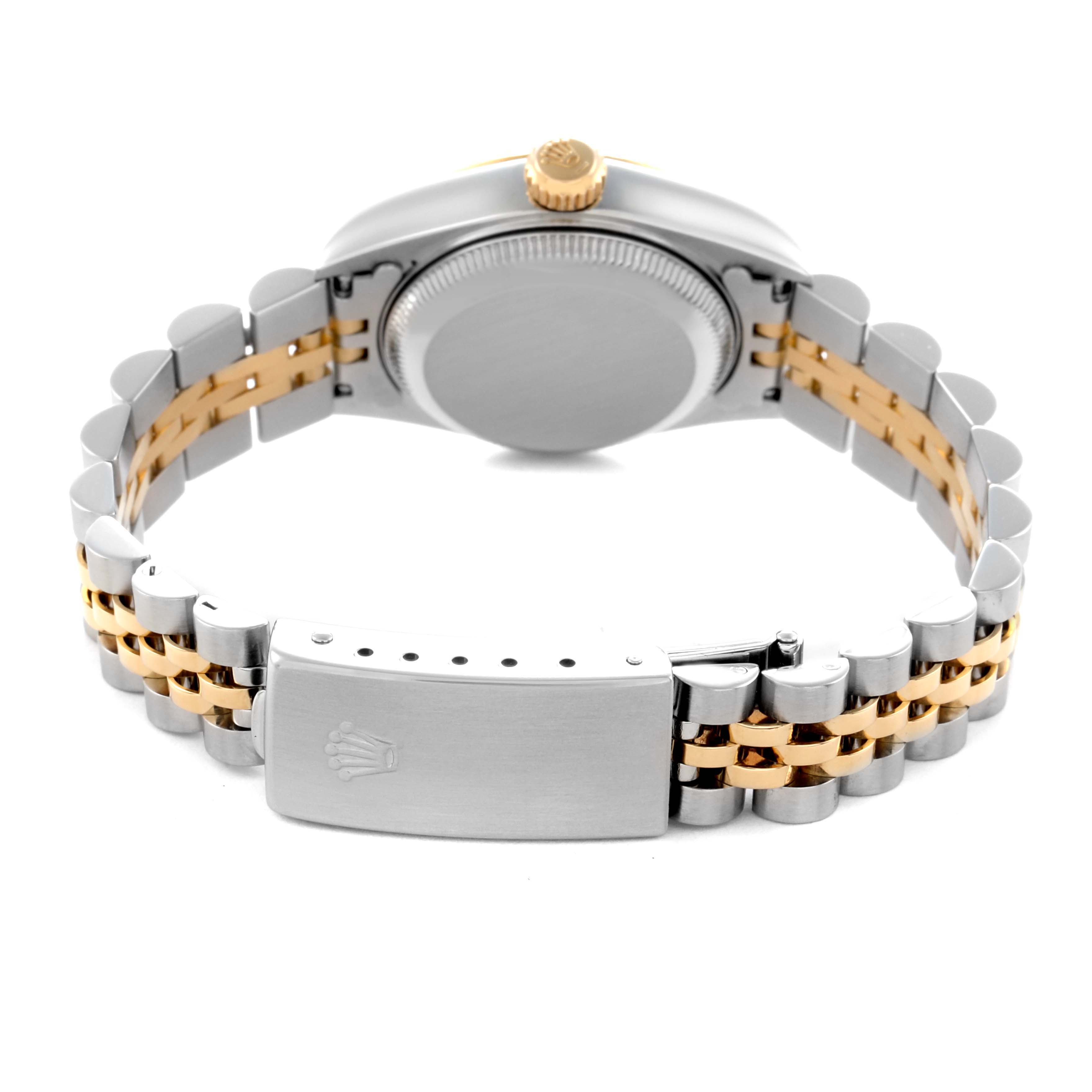 The image shows the back view of a Rolex Datejust 79173 Women
s Steel and Gold (two tone) Champagne Dial 79173 Women
s Steel and Gold (two tone) Champagne Dial watch, focusing on the clasp, bracelet, and crown.