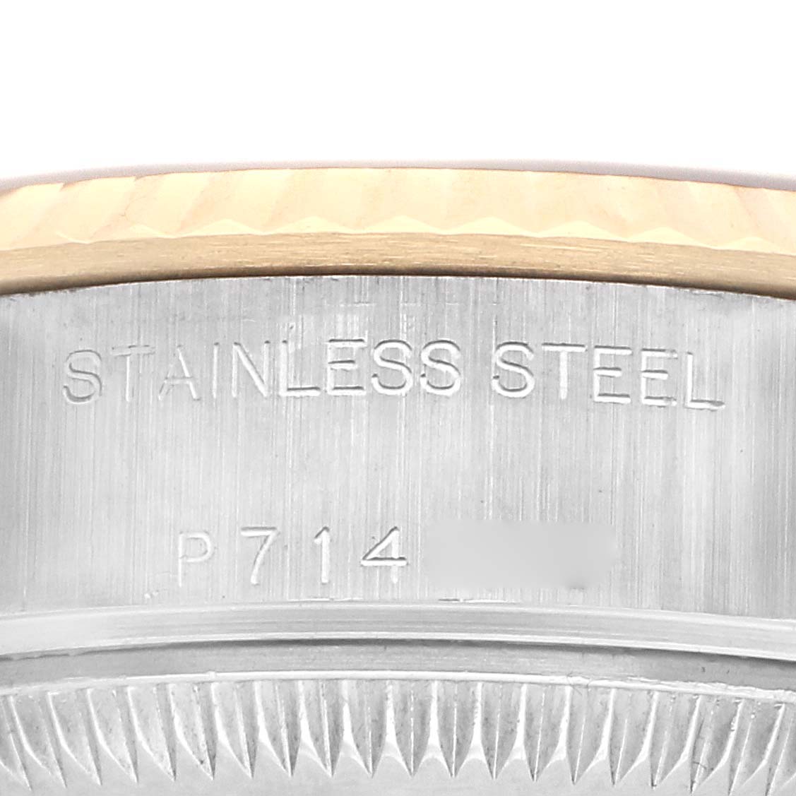 The image shows a close-up of the Rolex Datejust 79173 Women
s Steel and Gold (two tone) Champagne Dial 79173 Women
s Steel and Gold (two tone) Champagne Dial
s case side, detailing "STAINLESS STEEL" engraving.