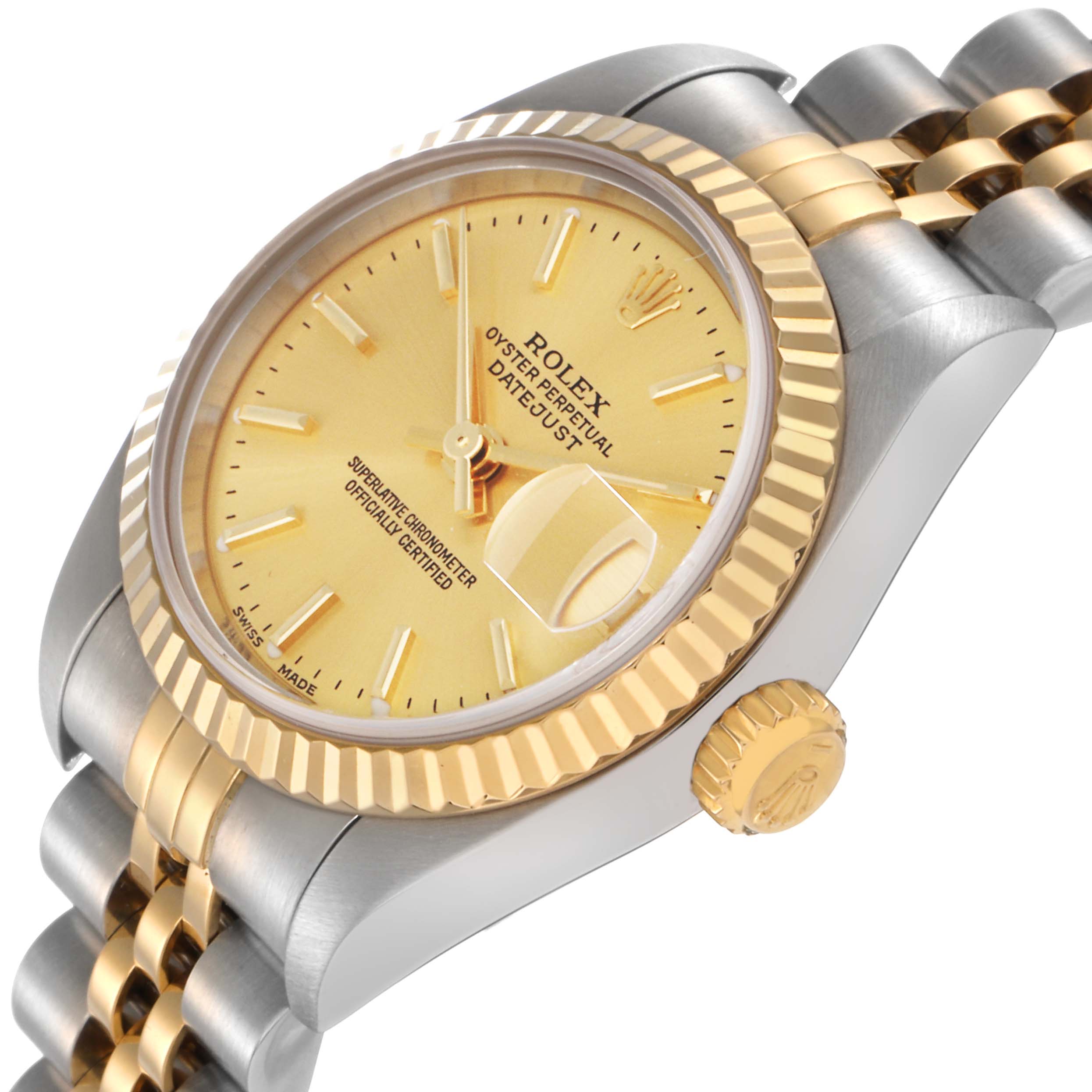 The Rolex Datejust 79173 Women
s Steel and Gold (two tone) Champagne Dial 79173 Women
s Steel and Gold (two tone) Champagne Dial watch is shown at an angle highlighting the dial, fluted bezel, crown, and part of the bracelet.