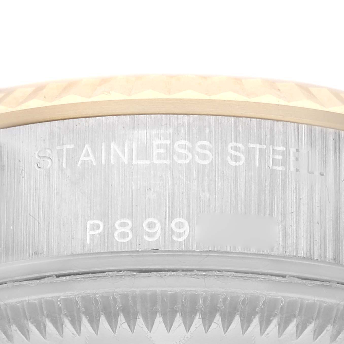 This close-up image shows the engraved stainless steel case back and part of the bezel of a Rolex Datejust 79173G Women's Steel and Gold (two tone) Champagne Dial 79173G Women's Steel and Gold (two tone) Champagne Dial watch.