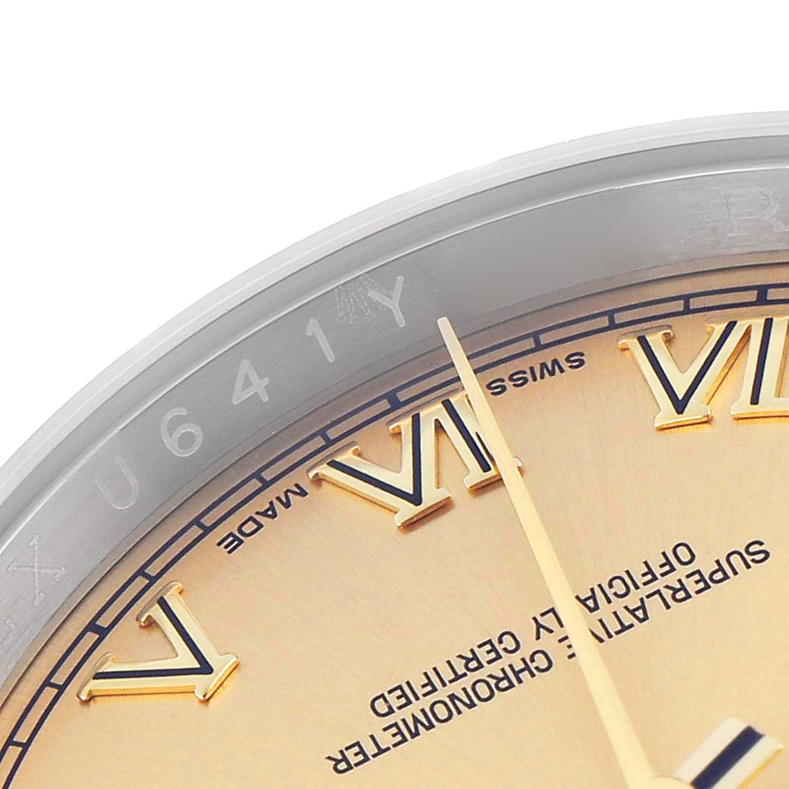 The image shows a close-up of the Rolex Datejust 116233 Men
s Steel and Gold (two tone) Champagne Dial 116233 Men
s Steel and Gold (two tone) Champagne Dial watch dial, highlighting Roman numerals and part of the rehaut with engraving.