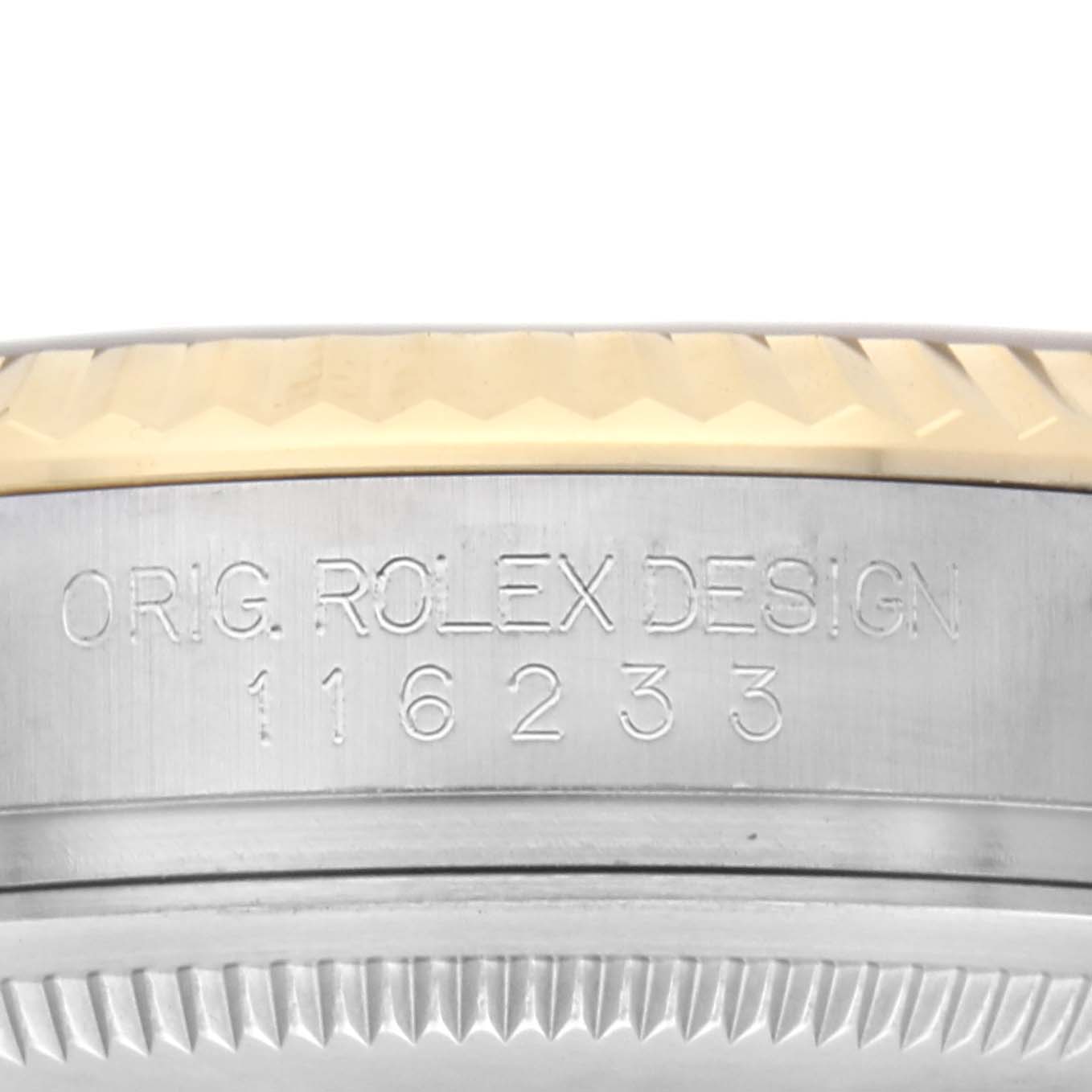 The image shows a close-up side view of the Rolex Datejust 116233 Men
s Steel and Gold (two tone) Champagne Dial 116233 Men
s Steel and Gold (two tone) Champagne Dial
s engraved case side and fluted bezel.