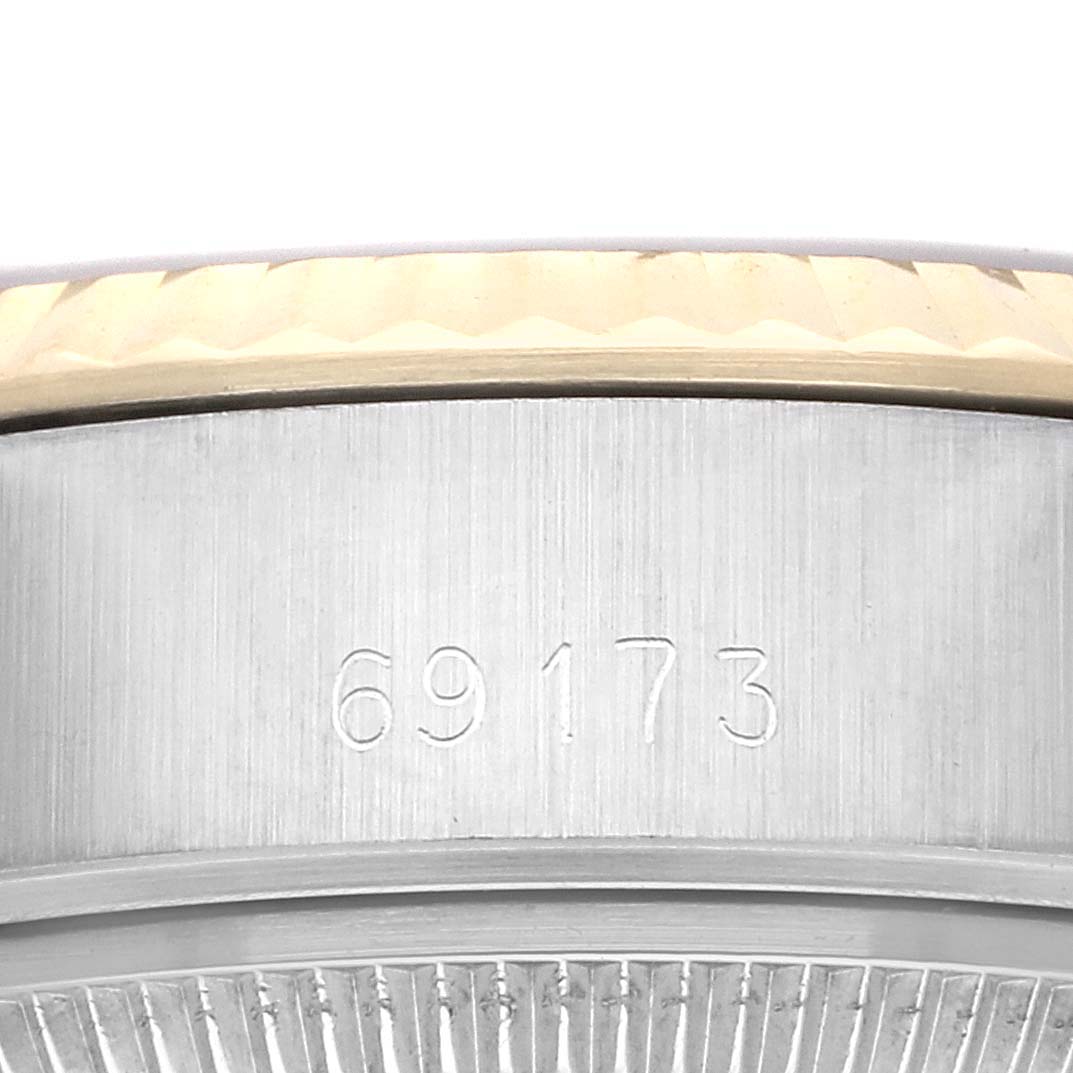 The image shows a close-up of the Rolex Datejust 69173 Women
s Steel and Gold (two tone) Champagne Dial 69173 Women
s Steel and Gold (two tone) Champagne Dial model
s case, highlighting its engraved model number.