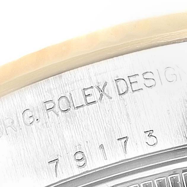 This close-up image shows the engraved text and serial number on the case side of a Rolex Datejust 79173 Women
s Steel and Gold (two tone) Champagne Dial 79173 Women
s Steel and Gold (two tone) Champagne Dial watch.