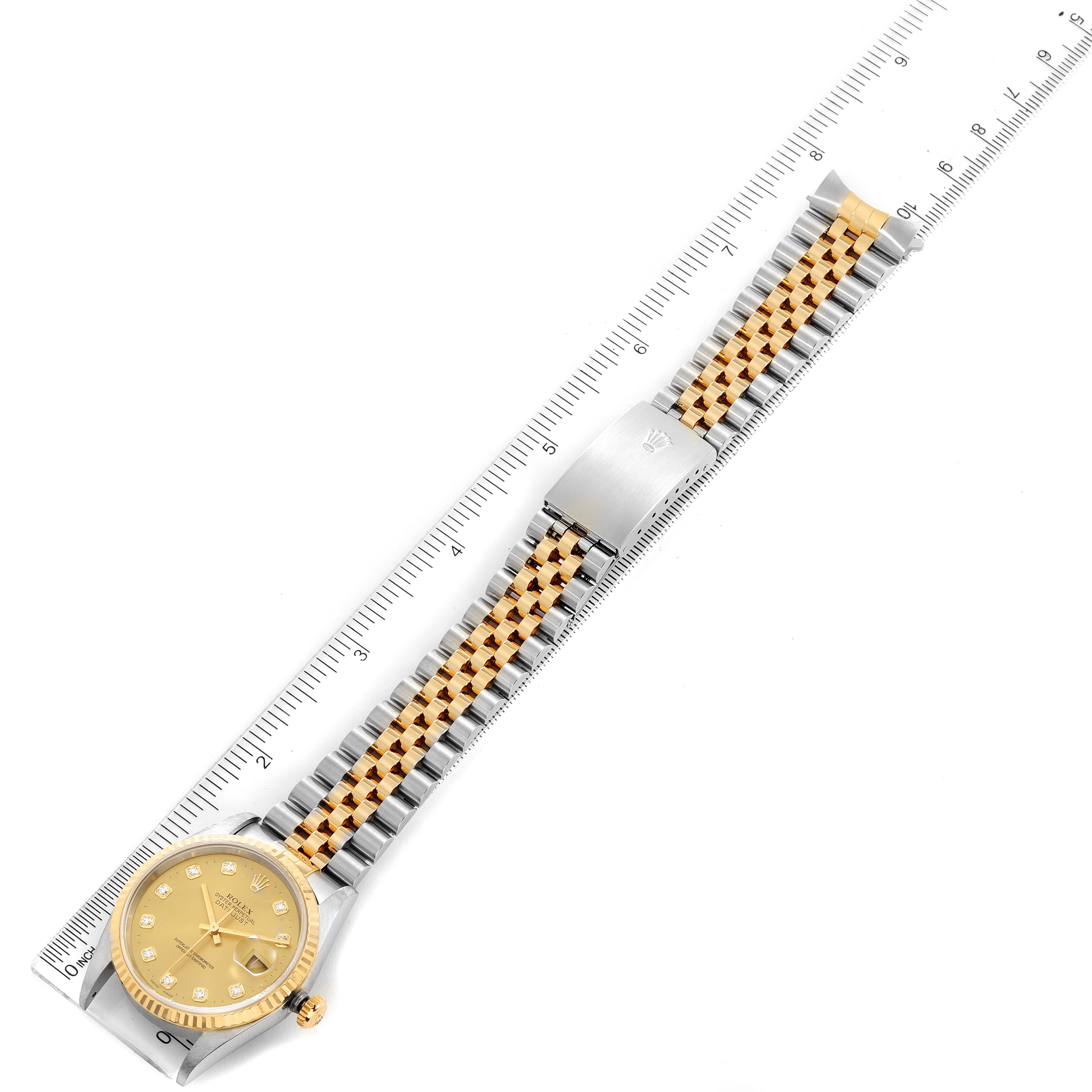 The image shows a Rolex Datejust 16233 Men's Steel and Gold (two tone) Champagne Dial 16233 Men's Steel and Gold (two tone) Champagne Dial watch laid flat, displaying the gold face, bezel, and two-tone bracelet with a measuring ruler.