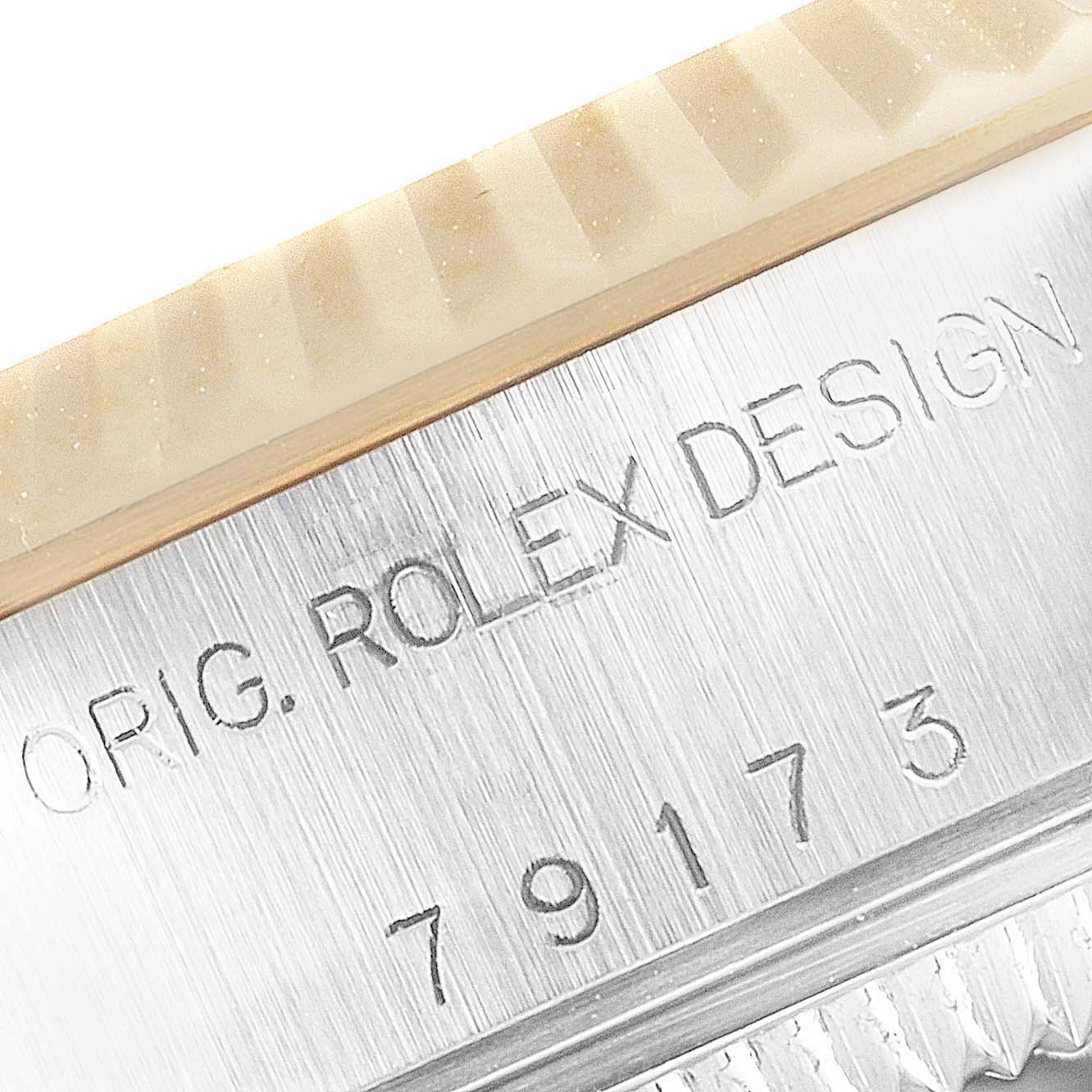 The image shows a close-up of the model number and "ORIG. ROLEX DESIGN" engraving on the case of a Rolex Datejust 79173 Women's Steel and Gold (two tone) Mother of Pearl Dial 79173 Women's Steel and Gold (two tone) Mother of Pearl Dial watch.