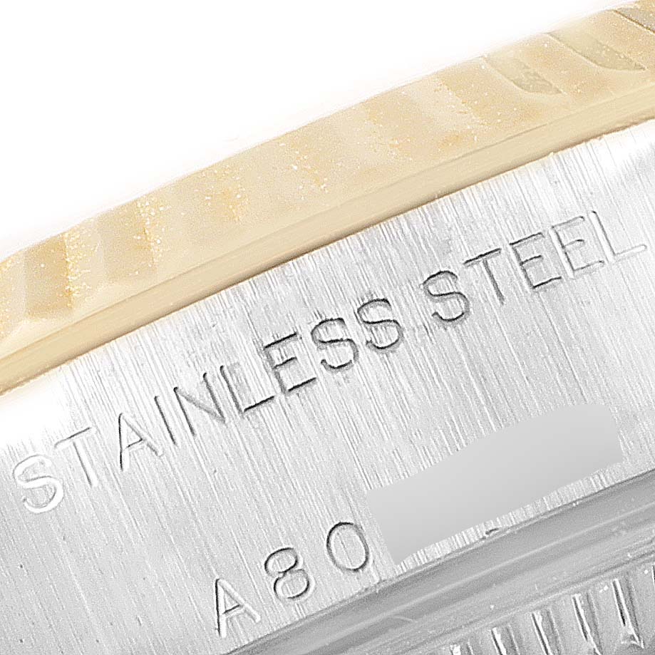 The image shows a close-up of the side of the bezel and case of a Rolex Datejust 79173 Women's Steel and Gold (two tone) Mother of Pearl Dial 79173 Women's Steel and Gold (two tone) Mother of Pearl Dial, highlighting the "Stainless Steel" engraving.