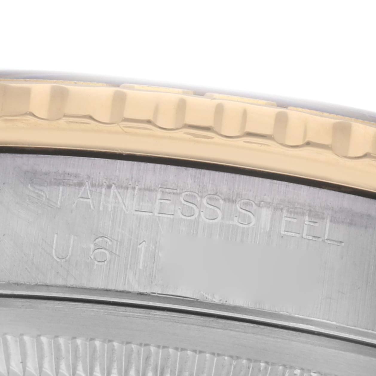 The image shows a close-up of the side of the Rolex Turn-o-Graph 16263 Men
s Steel and Gold (two tone) Black Dial 16263 Men
s Steel and Gold (two tone) Black Dial, focusing on the bezel and the "stainless steel" engraving.