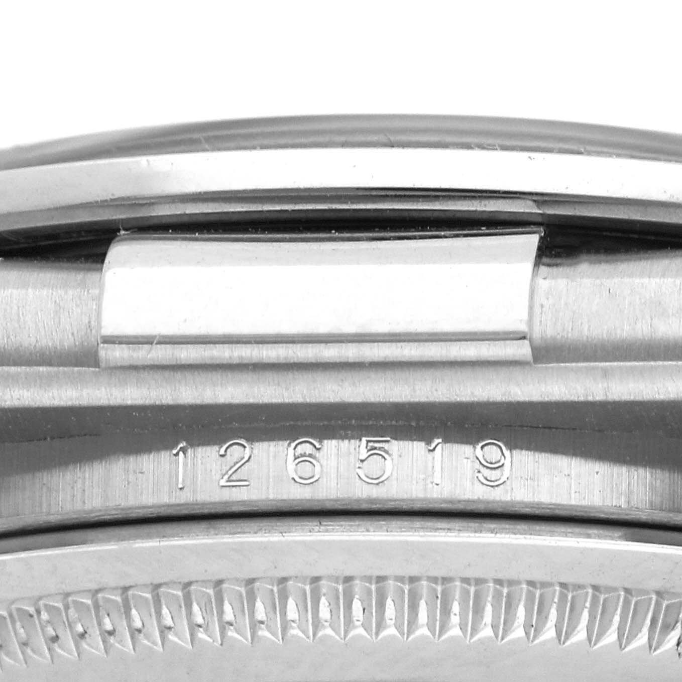 The image shows a close-up of the case side and bezel with engraving on the Rolex Daytona 126519 Men
s White Gold Black Dial 126519 Men
s White Gold Black Dial watch.