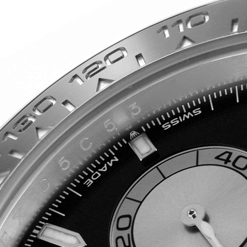 The image shows a close-up of the bezel and part of the dial of a Rolex Daytona 126519 Men
s White Gold Black Dial 126519 Men
s White Gold Black Dial watch.