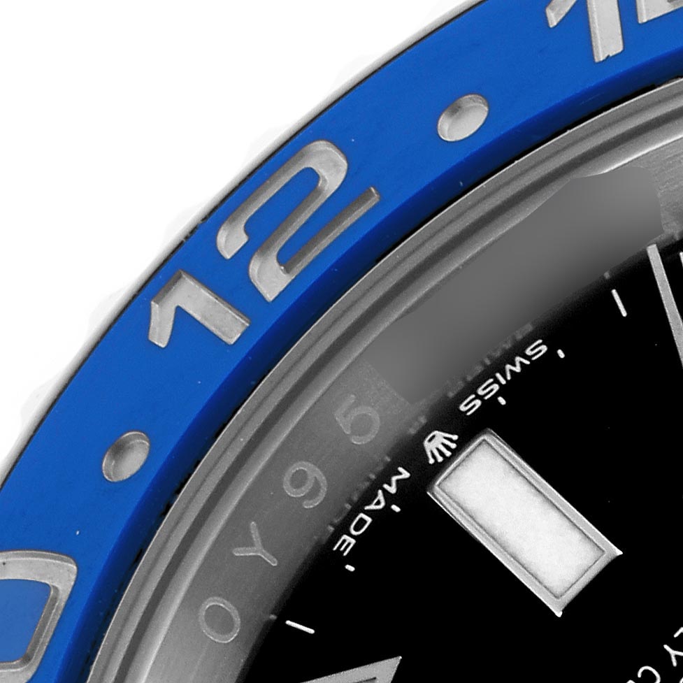 The image shows a close-up of the Rolex GMT-Master 126710 Men
s Stainless Steel Black Dial 126710 Men
s Stainless Steel Black Dial
s blue bezel and part of the dial.