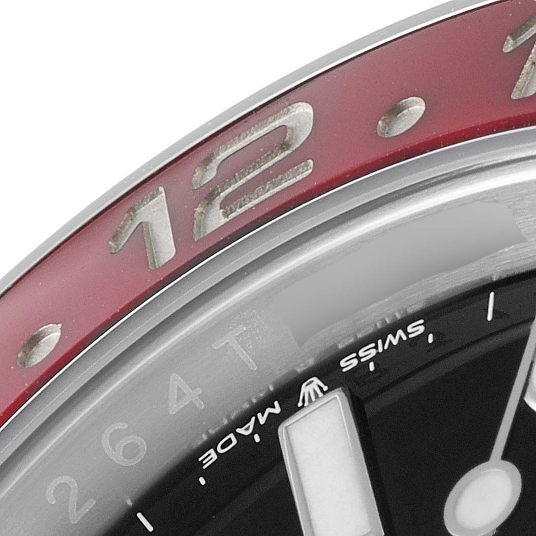 This close-up angle of the Rolex GMT-Master 126710 Men's Stainless Steel Black Dial 126710 Men's Stainless Steel Black Dial shows the bezel with "12" marking, the dial, and the "Swiss Made" text.