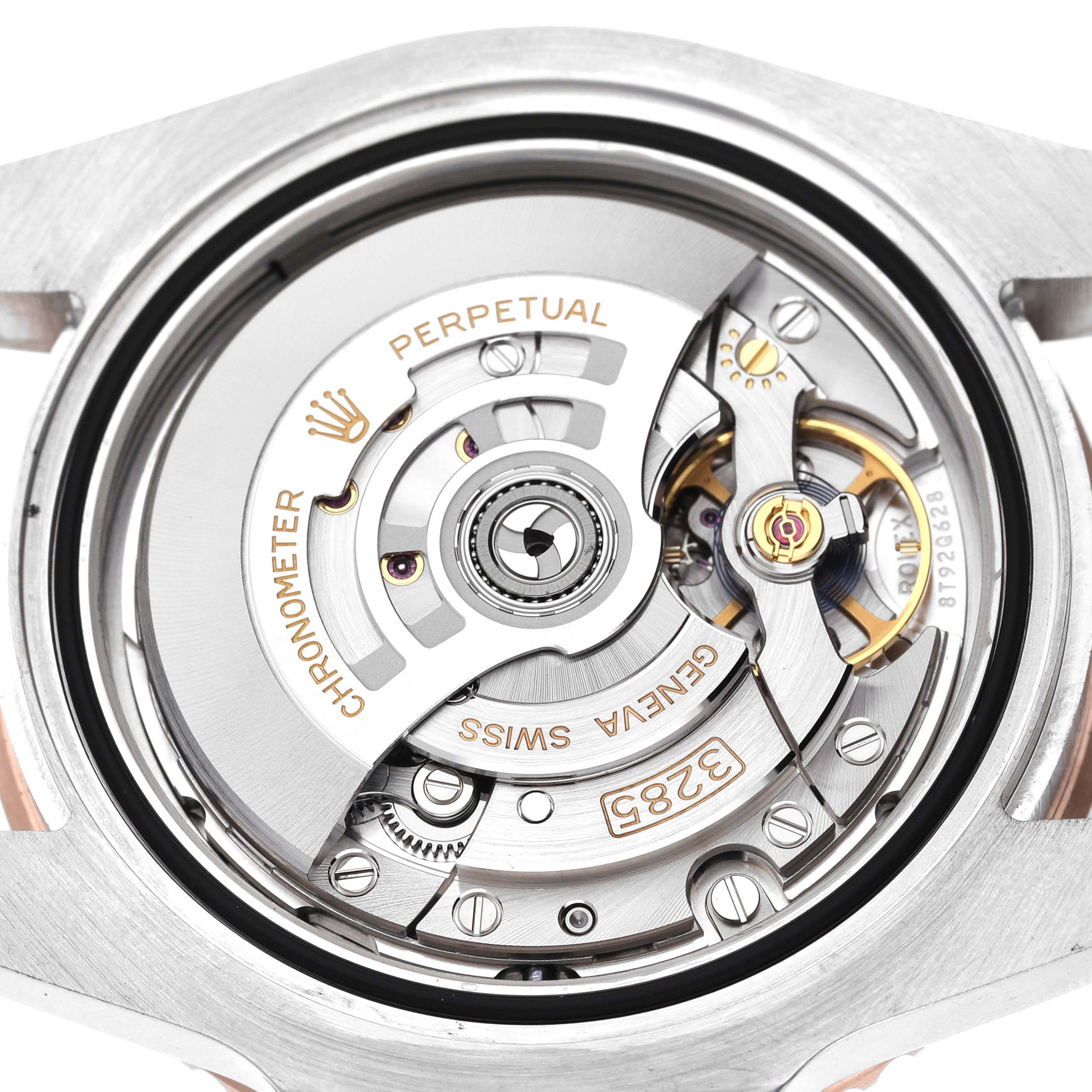 This image shows a close-up, top-down view of the movement within a Rolex GMT-Master 126711CHNR Men's Steel and Gold (two tone) Black Dial 126711CHNR Men's Steel and Gold (two tone) Black Dial watch.