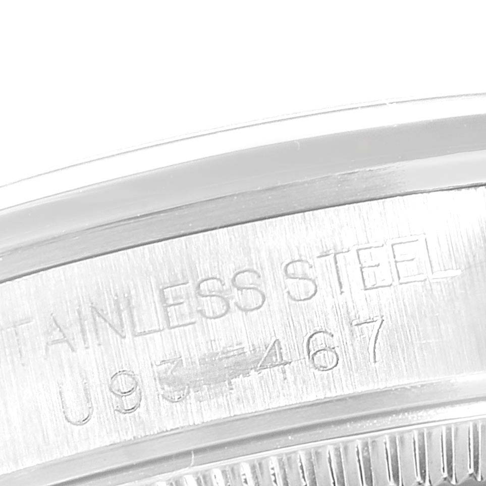 This image is a close-up of the serial number engraving on the stainless steel casing of a Rolex Mid-Size 67480 Women
s Stainless Steel Blue Dial 67480 Women
s Stainless Steel Blue Dial model watch.