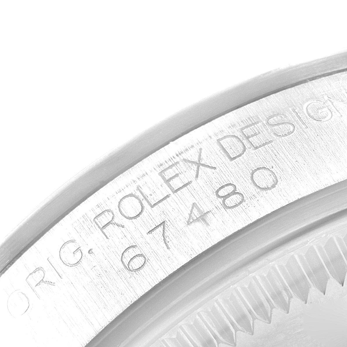 The image shows a close-up of the engraved bezel with the serial number of a Mid-Size Rolex watch, Model 67480.
