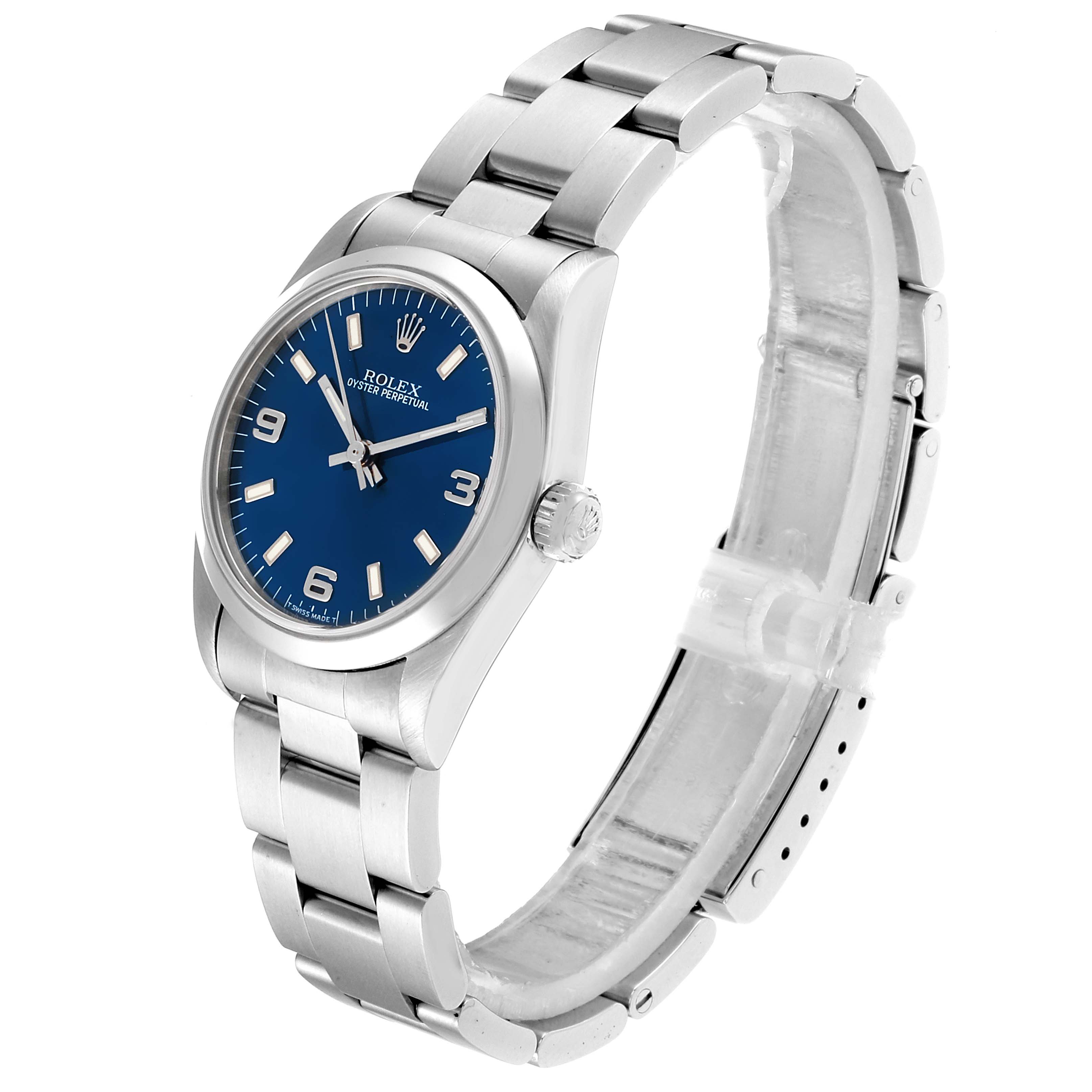 The image shows a side view of a Rolex Mid-Size 67480 Women
s Stainless Steel Blue Dial 67480 Women
s Stainless Steel Blue Dial Oyster Perpetual watch, displaying the bracelet, crown, and face with a blue dial.