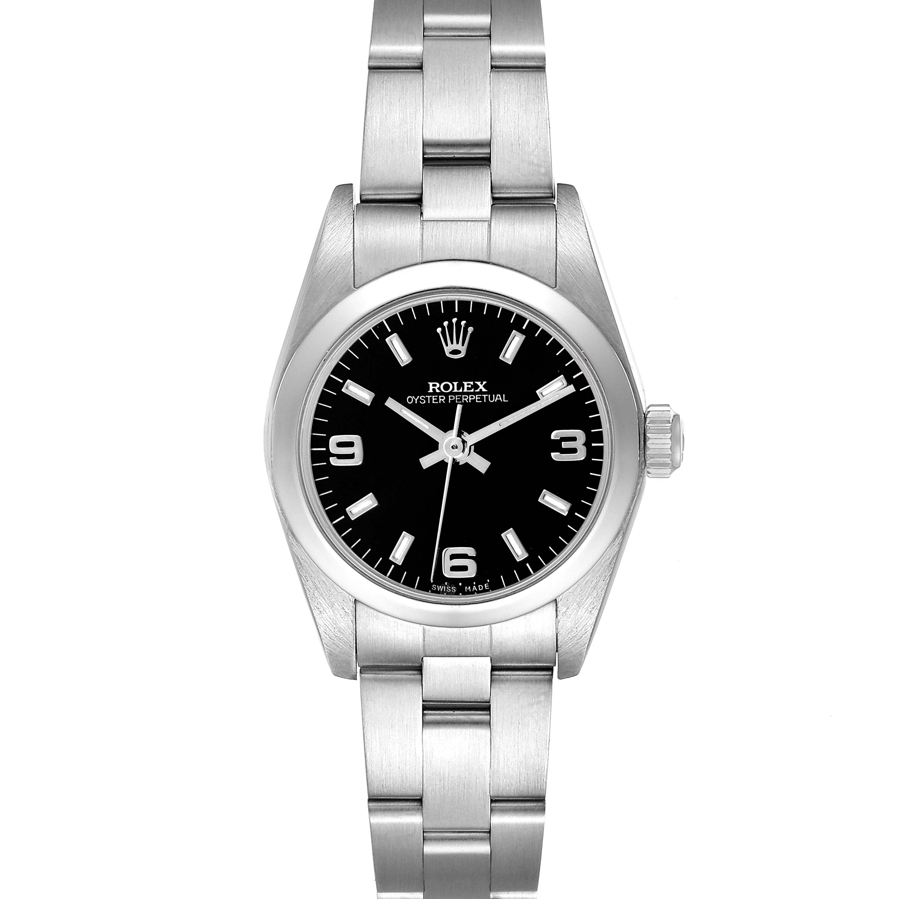 The Rolex Oyster Perpetual 76080 Women
s Stainless Steel Black Dial 76080 Women
s Stainless Steel Black Dial watch is shown from a front angle, displaying its black dial, silver indices, and stainless steel bracelet.