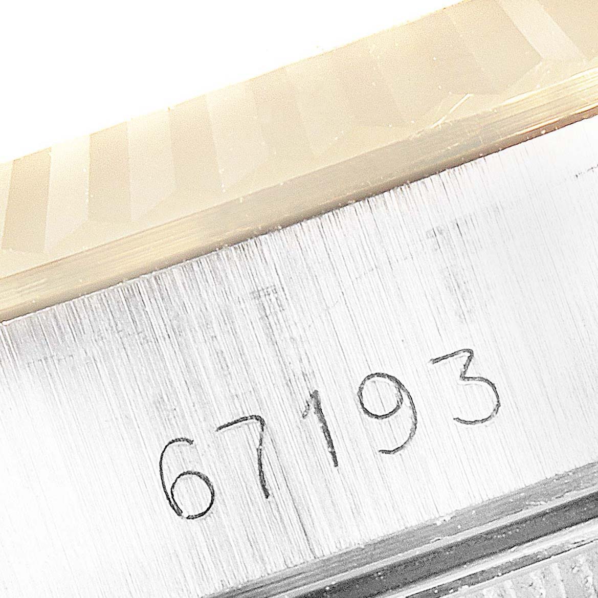 The image shows a close-up of the case side of the Rolex Oyster Perpetual 67193 Women
s Steel and Gold (two tone) Champagne Dial 67193 Women
s Steel and Gold (two tone) Champagne Dial, displaying the model number "67193."