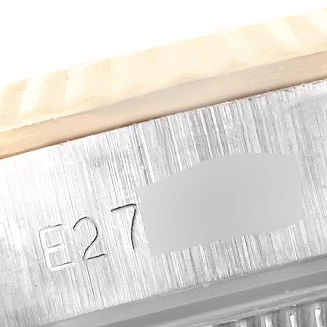 This close-up image shows the side engraving and brushed metal finish of the Rolex Oyster Perpetual 67193 Women
s Steel and Gold (two tone) Champagne Dial 67193 Women
s Steel and Gold (two tone) Champagne Dial watch case.